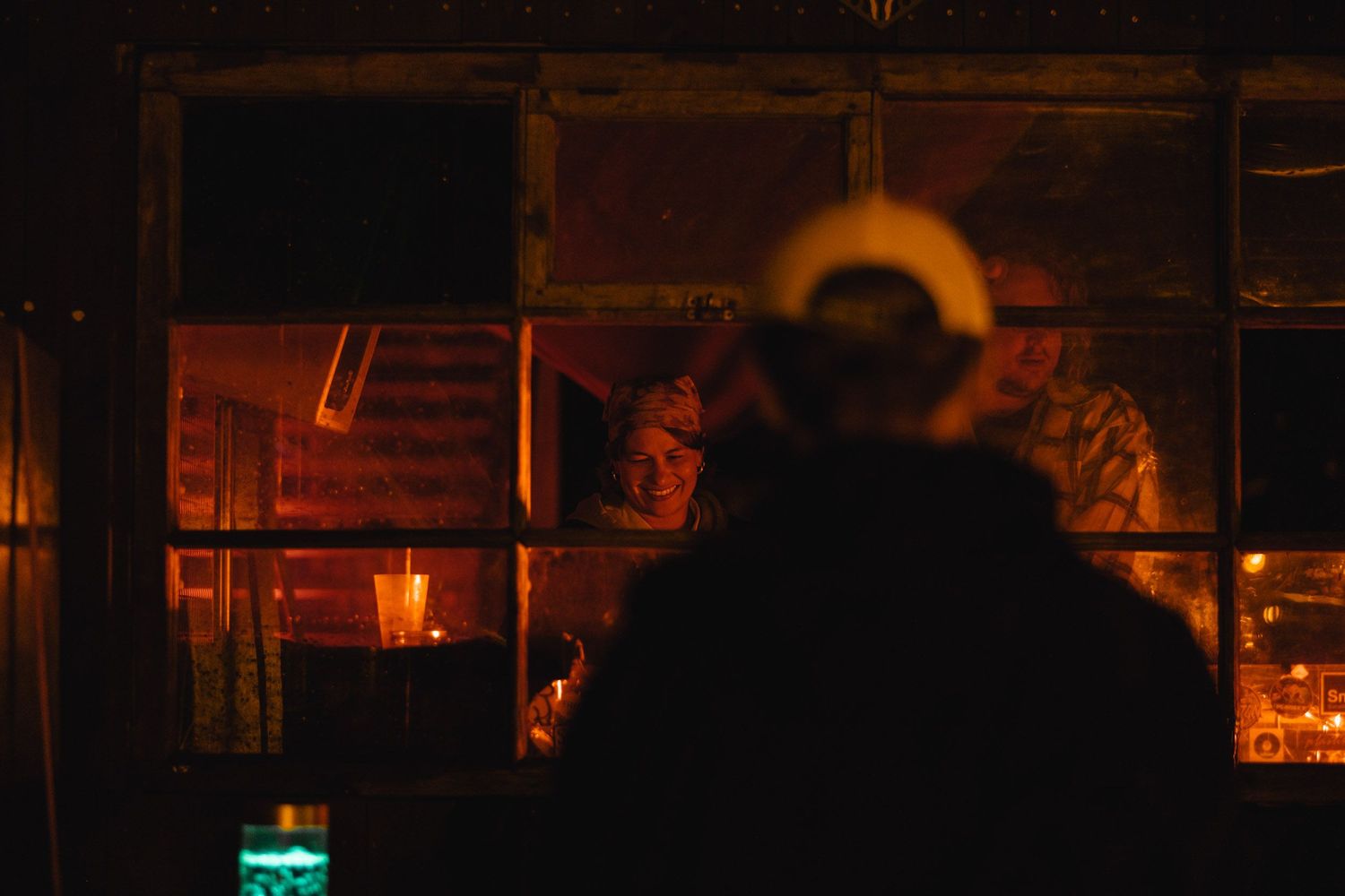 Atmospheric nighttime scene with warm lighting and silhouettes.