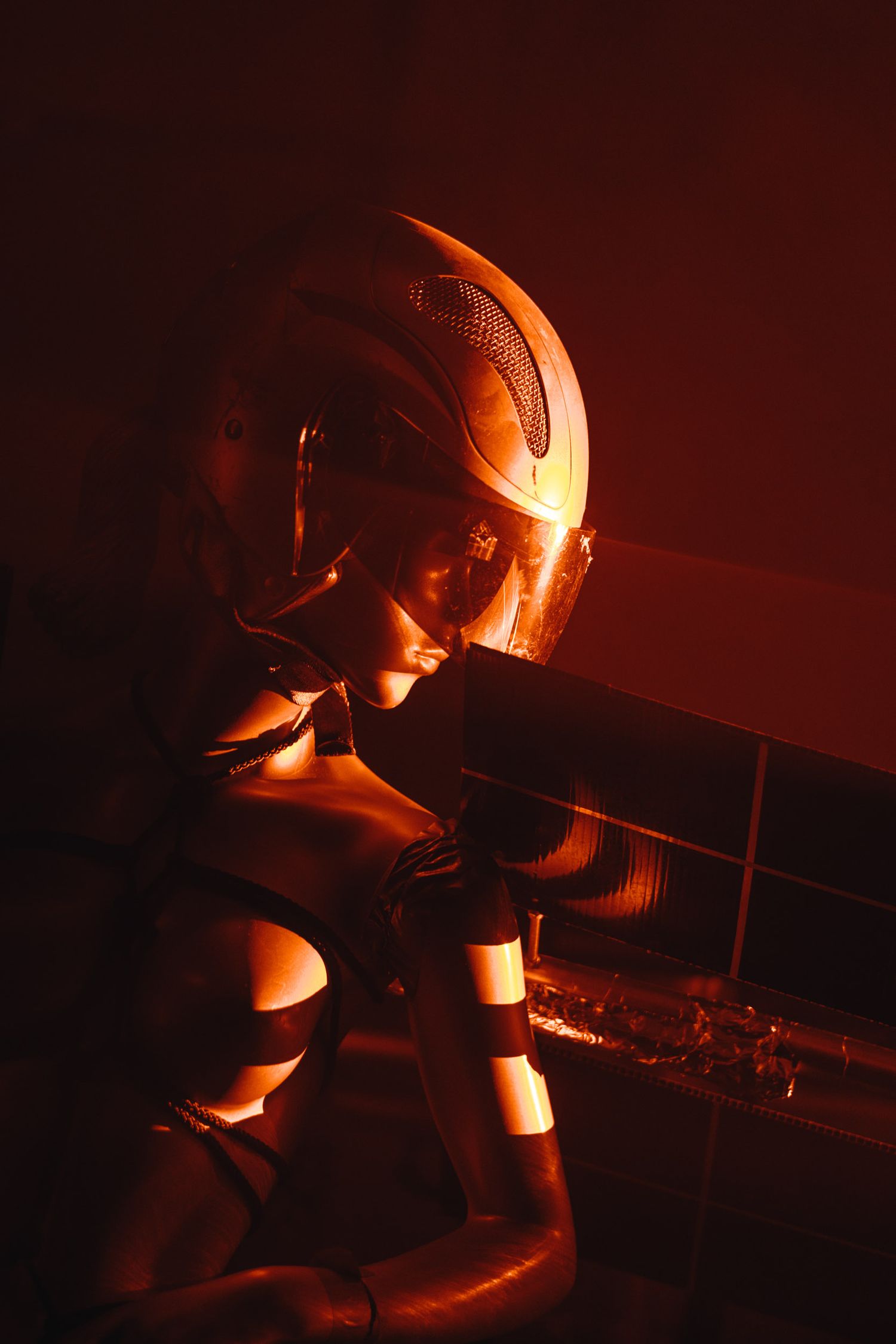 Abstract red-tinted artistic photograph with dramatic shadows and angles.