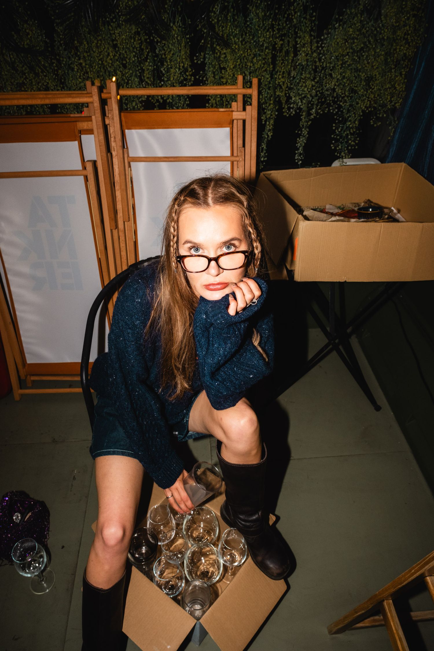 Person in dark clothing posing casually in an indoor setting.