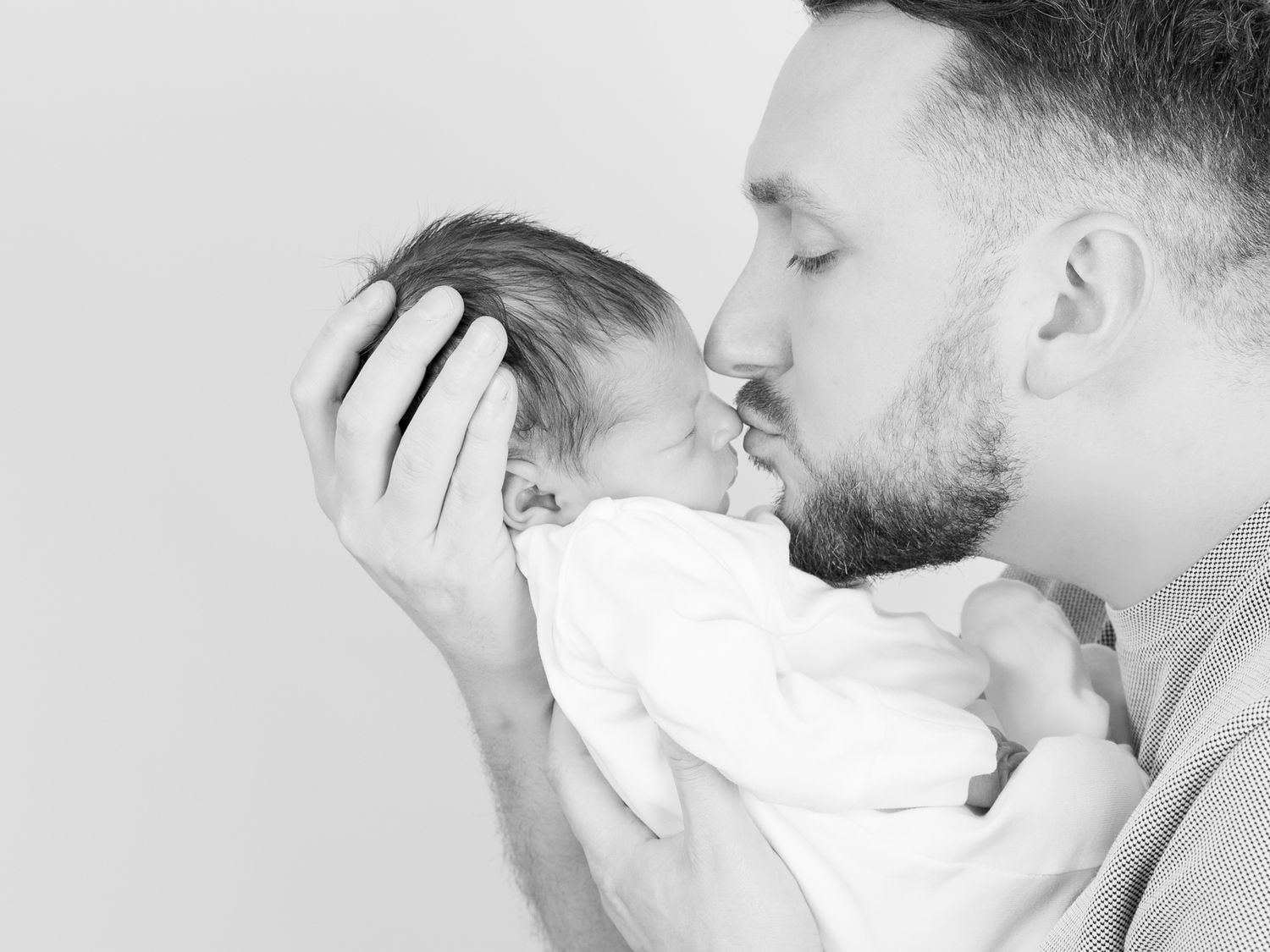 Black and white series of tender family moments with newborn.