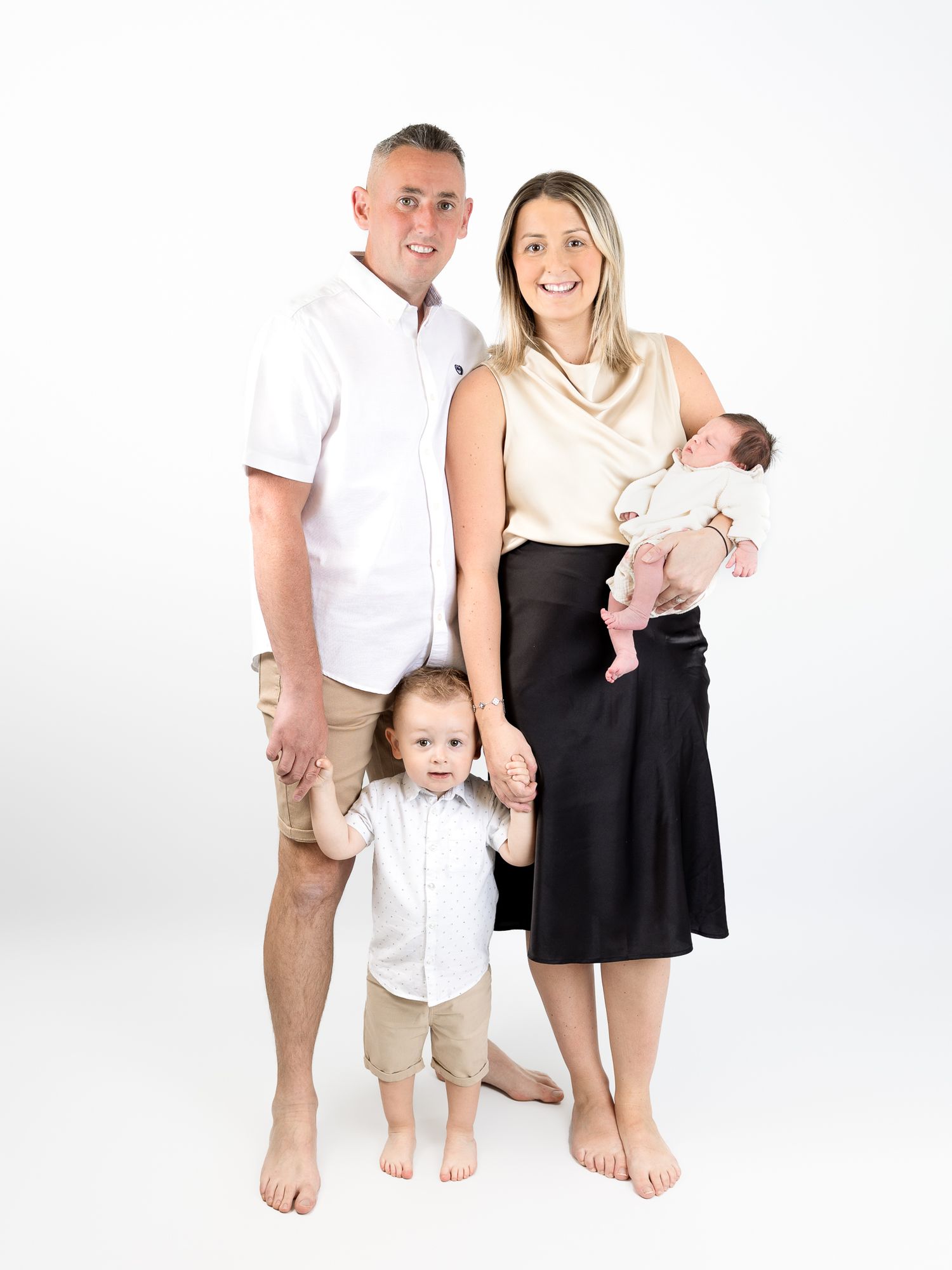 Barefoot family portrait series on white background showing casual poses.