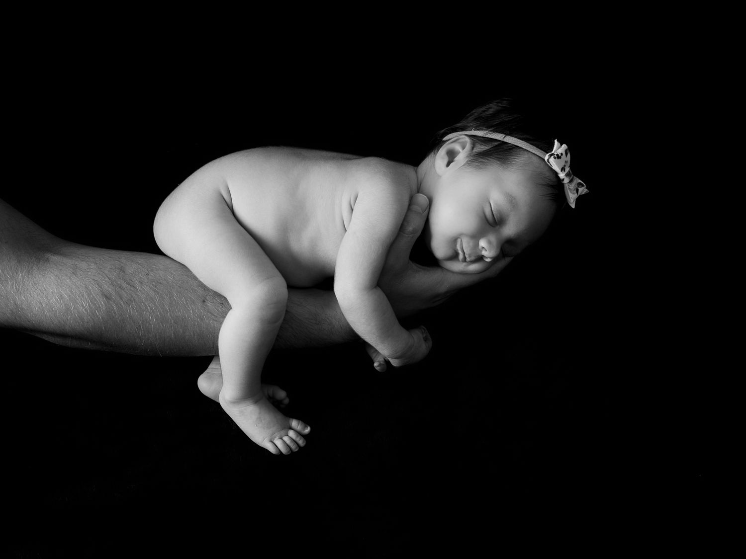 Artistic black and white portrait series of sleeping newborn baby.