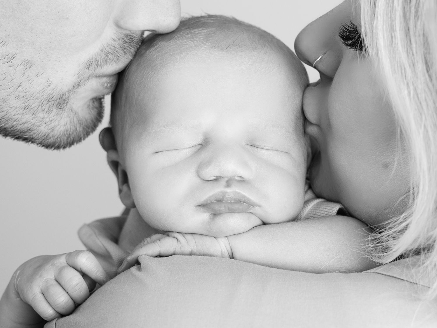 Series of intimate black and white maternity photos capturing tender moments.