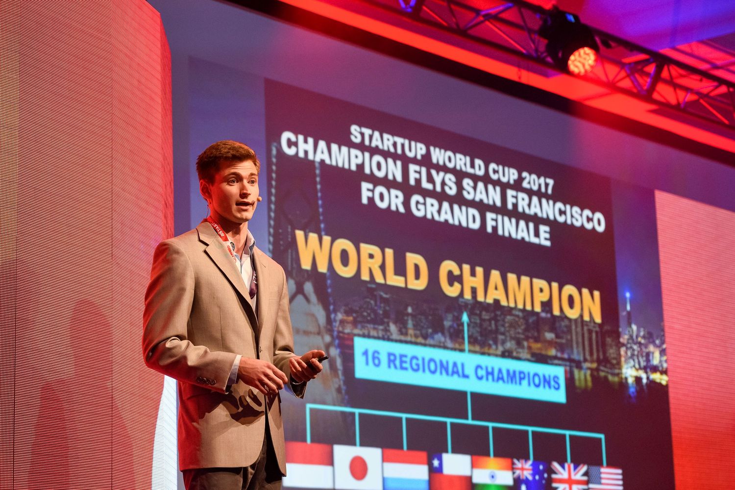 Professional culinary competition stage with red and blue lighting displaying World Champion text on screens.