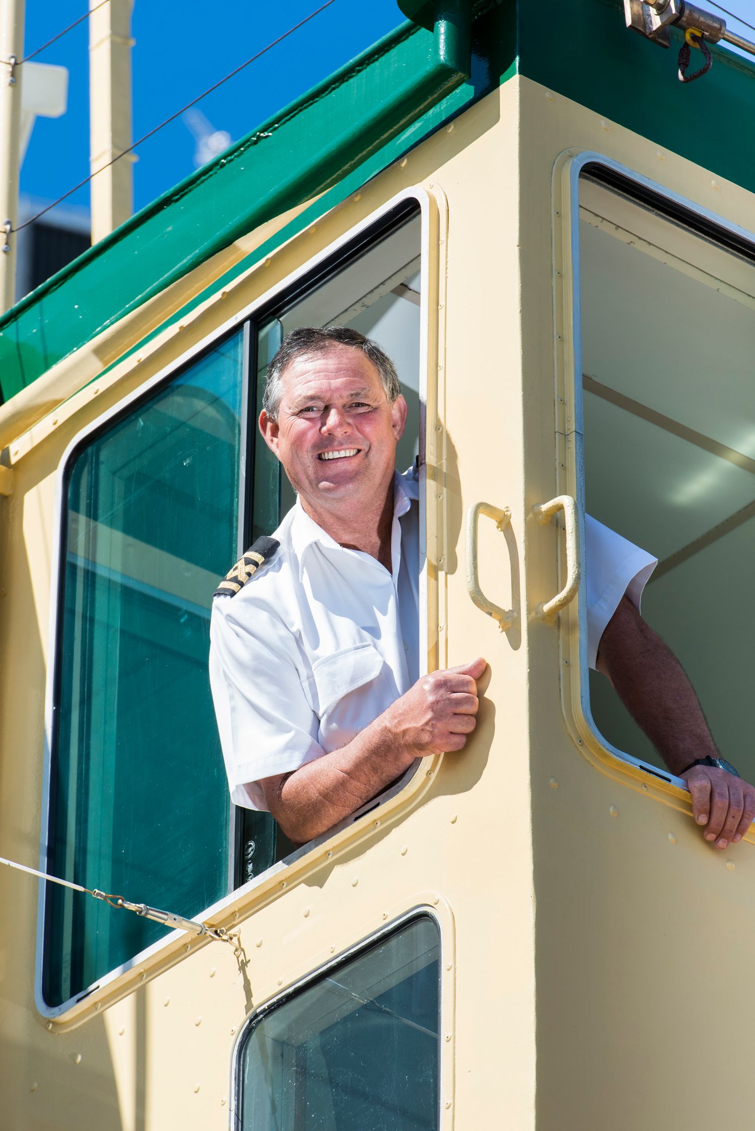 Multiple views through a train or tram window showing someone in white uniform.