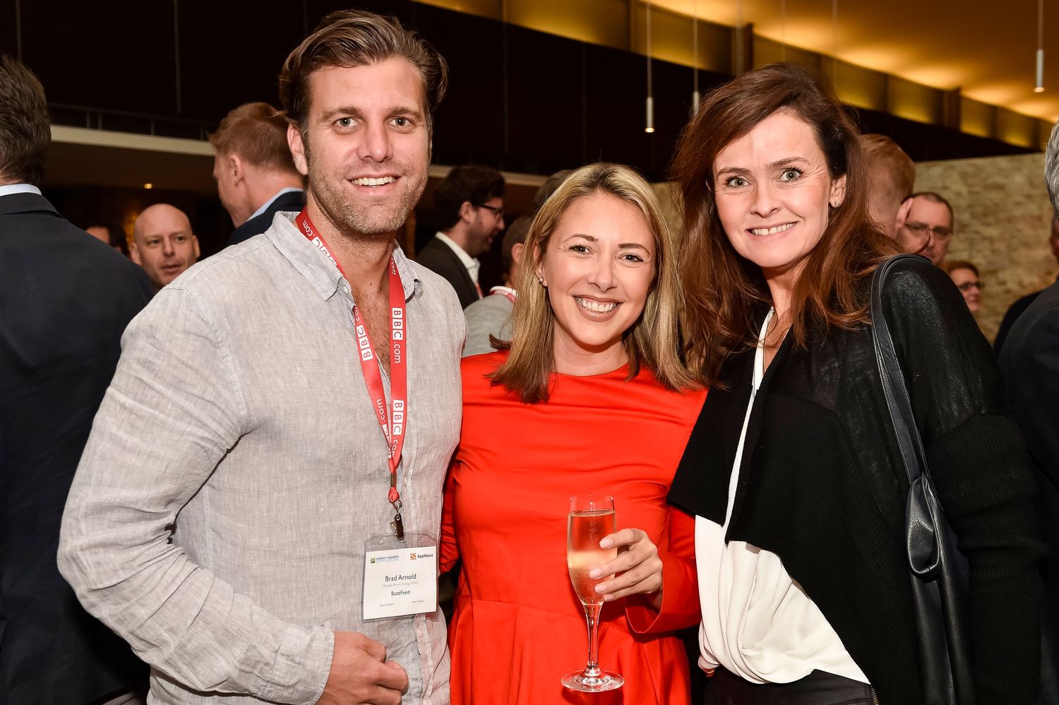 Event attendees socializing and holding drinks at an indoor business function at the Rydges Resort Hunter Valley.