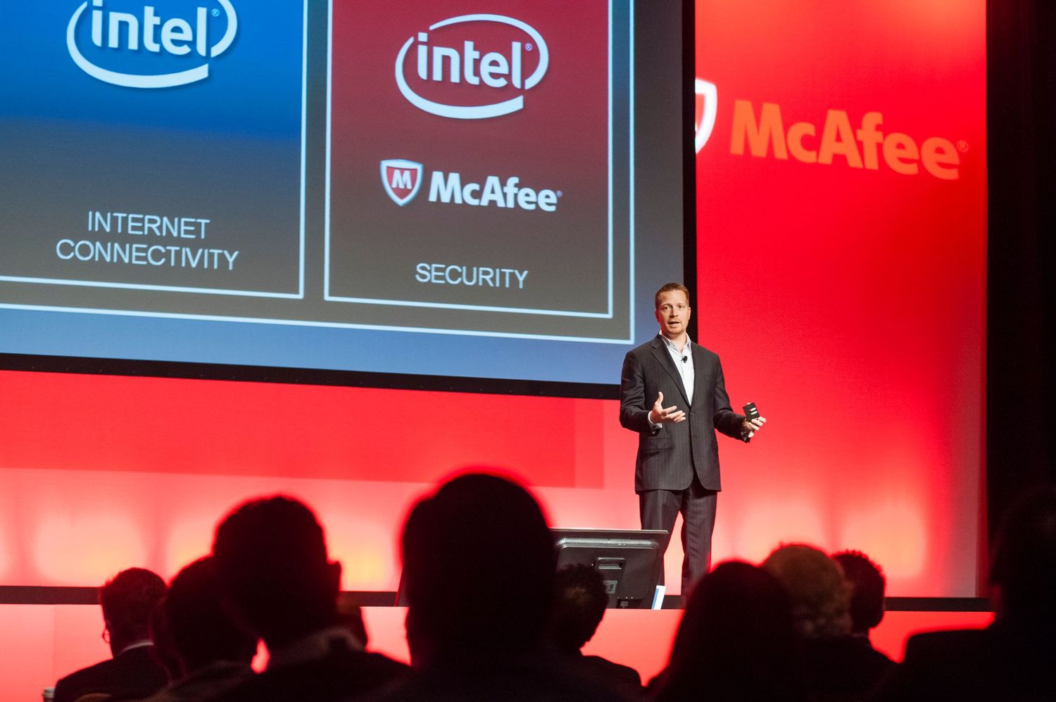 Technology conference stage at Sydney ICC showing Intel and Intel logos with presentation screens and red lighting effects.