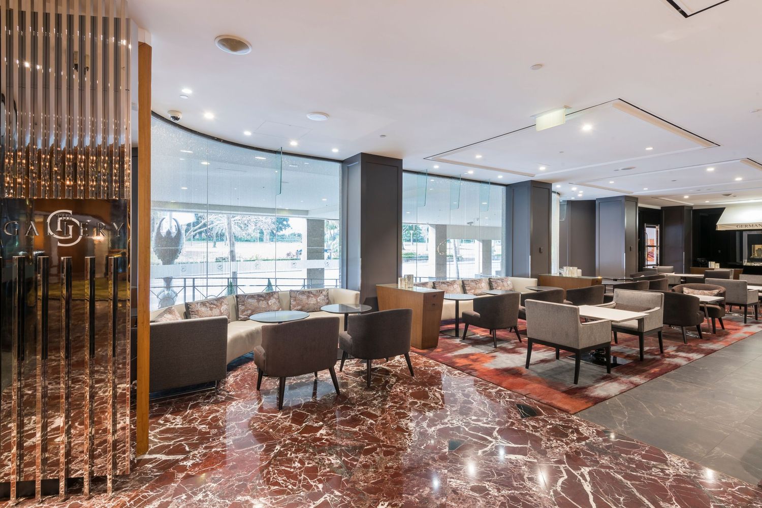 Modern restaurant interior with wooden dividers and marble flooring creating an elegant dining atmosphere.