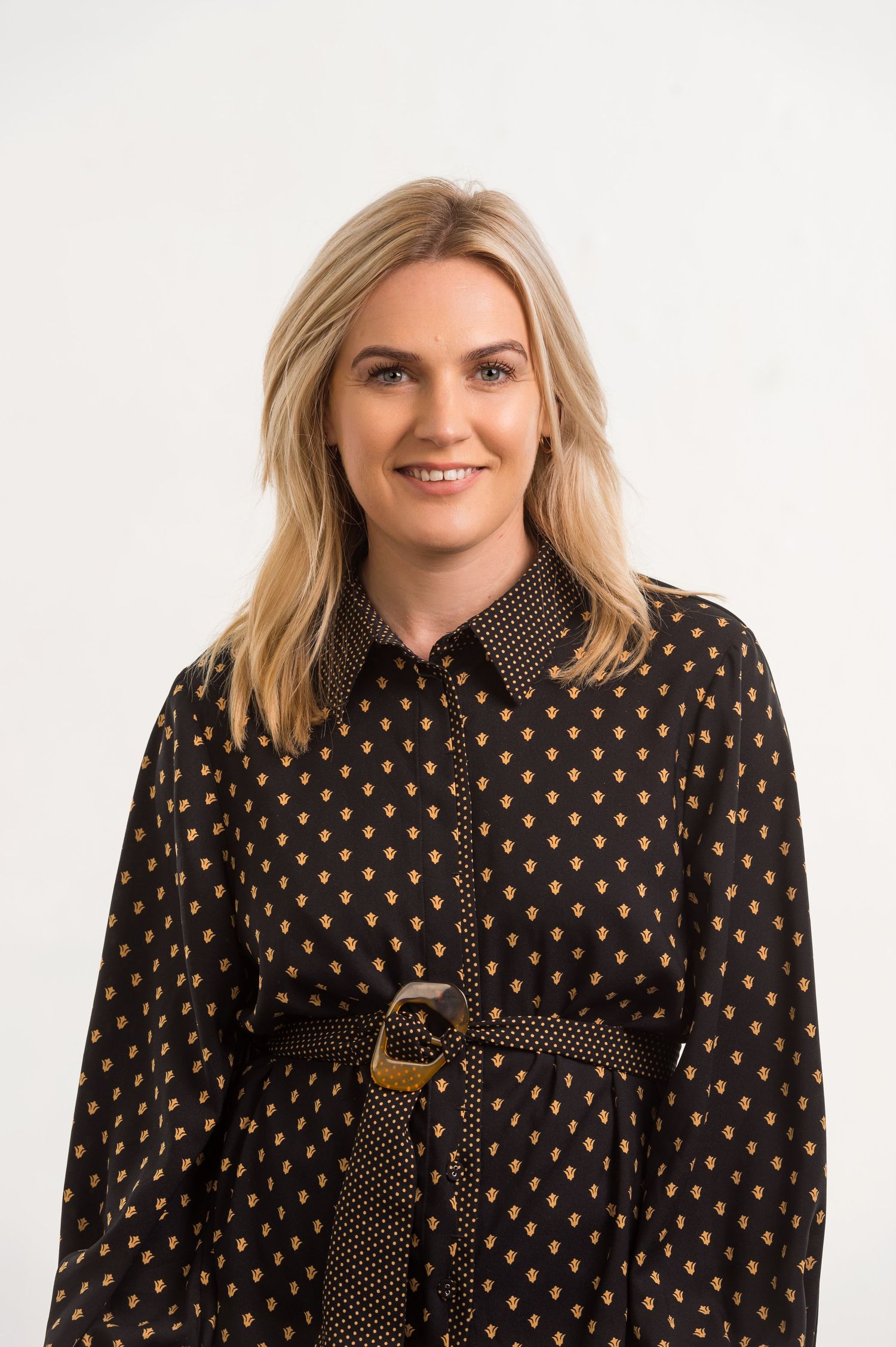Professional portraits featuring person in black polka dot dress.