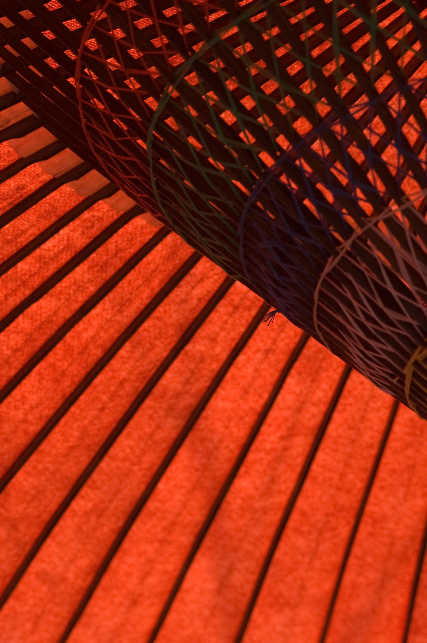 Close-up of a red and black umbrella or parasol showing detailed ribbed pattern and fabric texture.