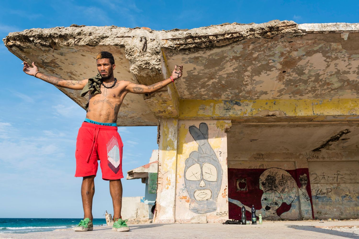 People enjoying leisure activities along a coastal bunker with ocean views.