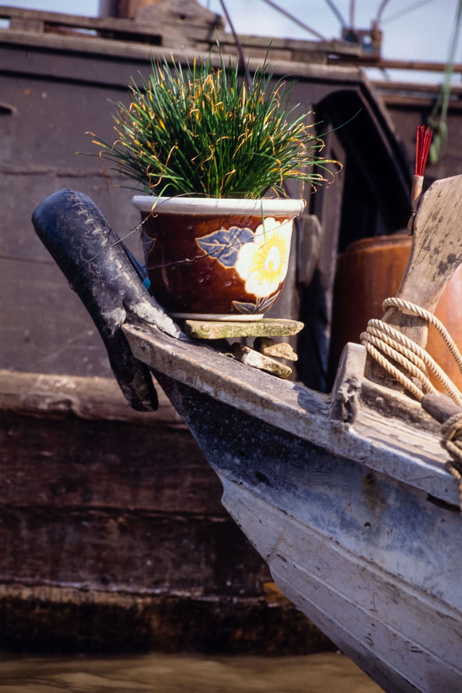 Wooden boats with decorative bows moored along a waterfront.