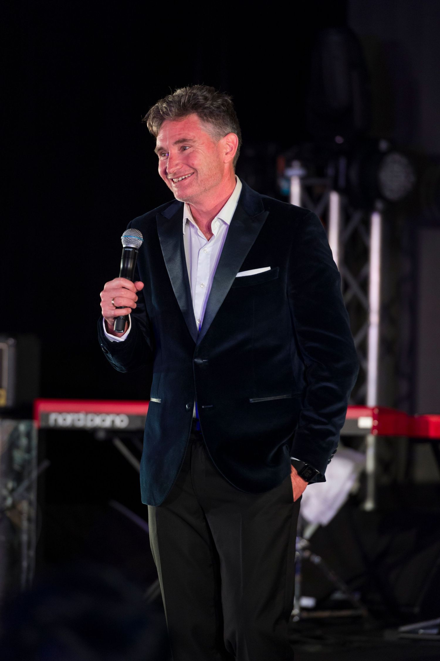 Australian stand-up comedian, television and radio presenter Dave Hughes on stage at a gala dinner sponsored event.