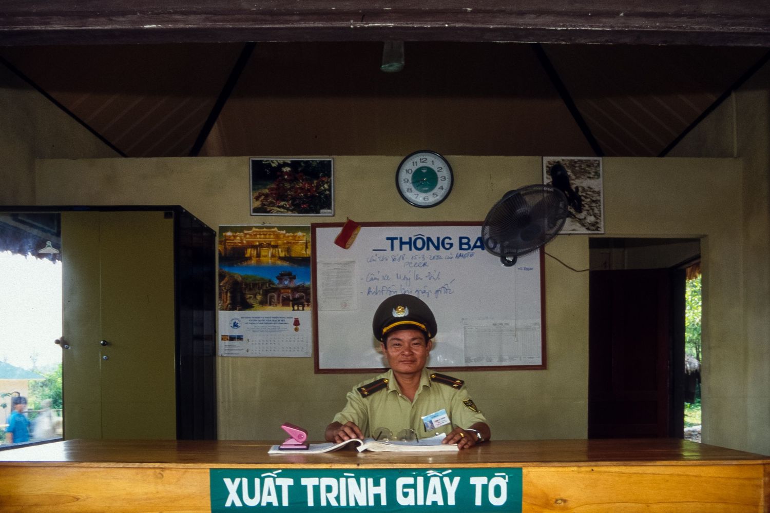 Interior view of an administrative office with traditional decor and signage.