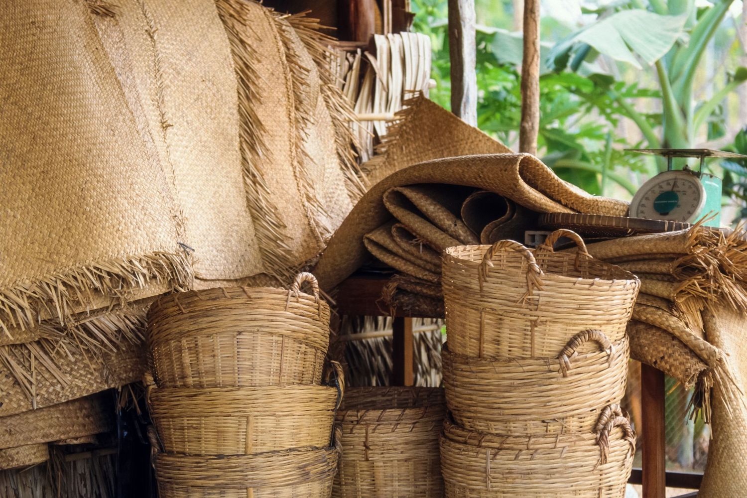 Traditional woven bamboo baskets stacked in rows for drying and storing harvested spices.