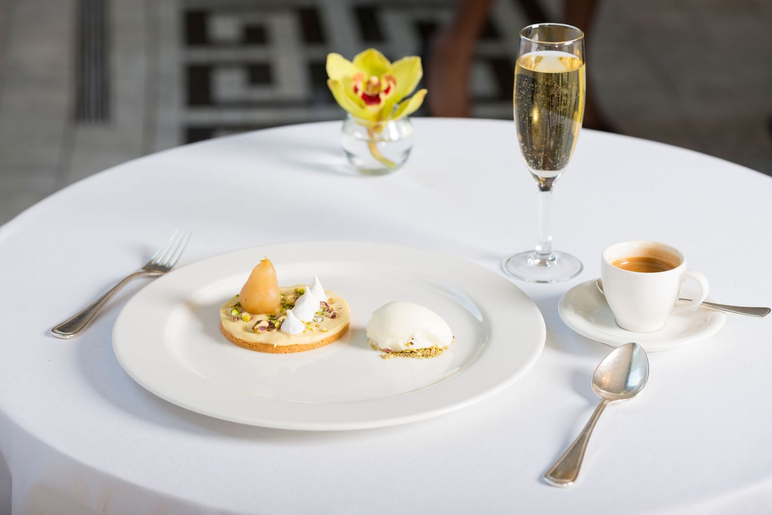 Elegant restaurant table setting with wine glasses and minimalist white plates.