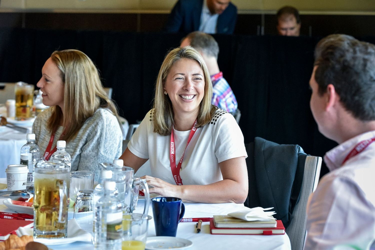 Business lunch meeting with attendees enjoying refreshments and conversation.