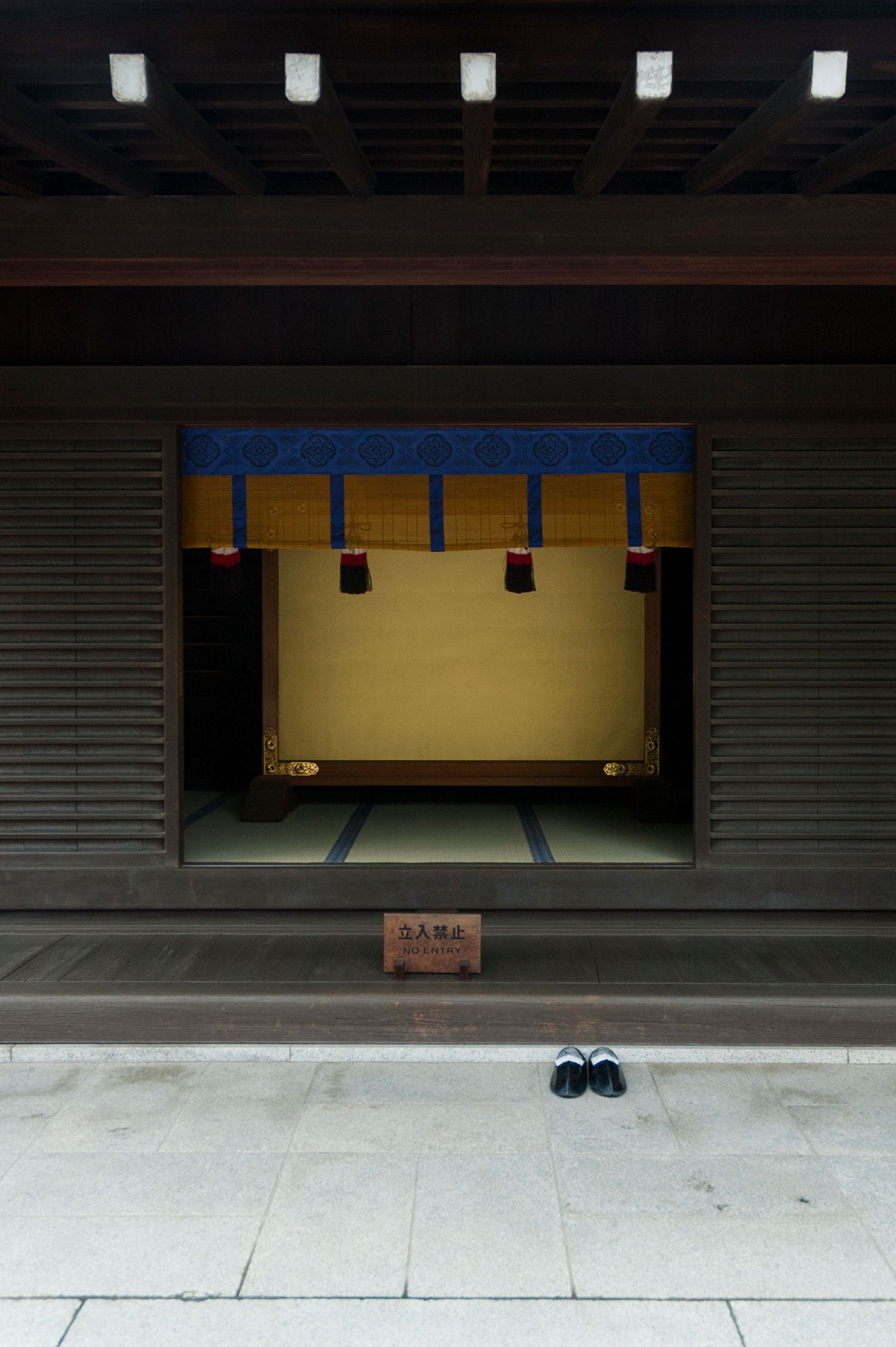 Minimalist Japanese temple entrance with clean lines and geometric shadows.
