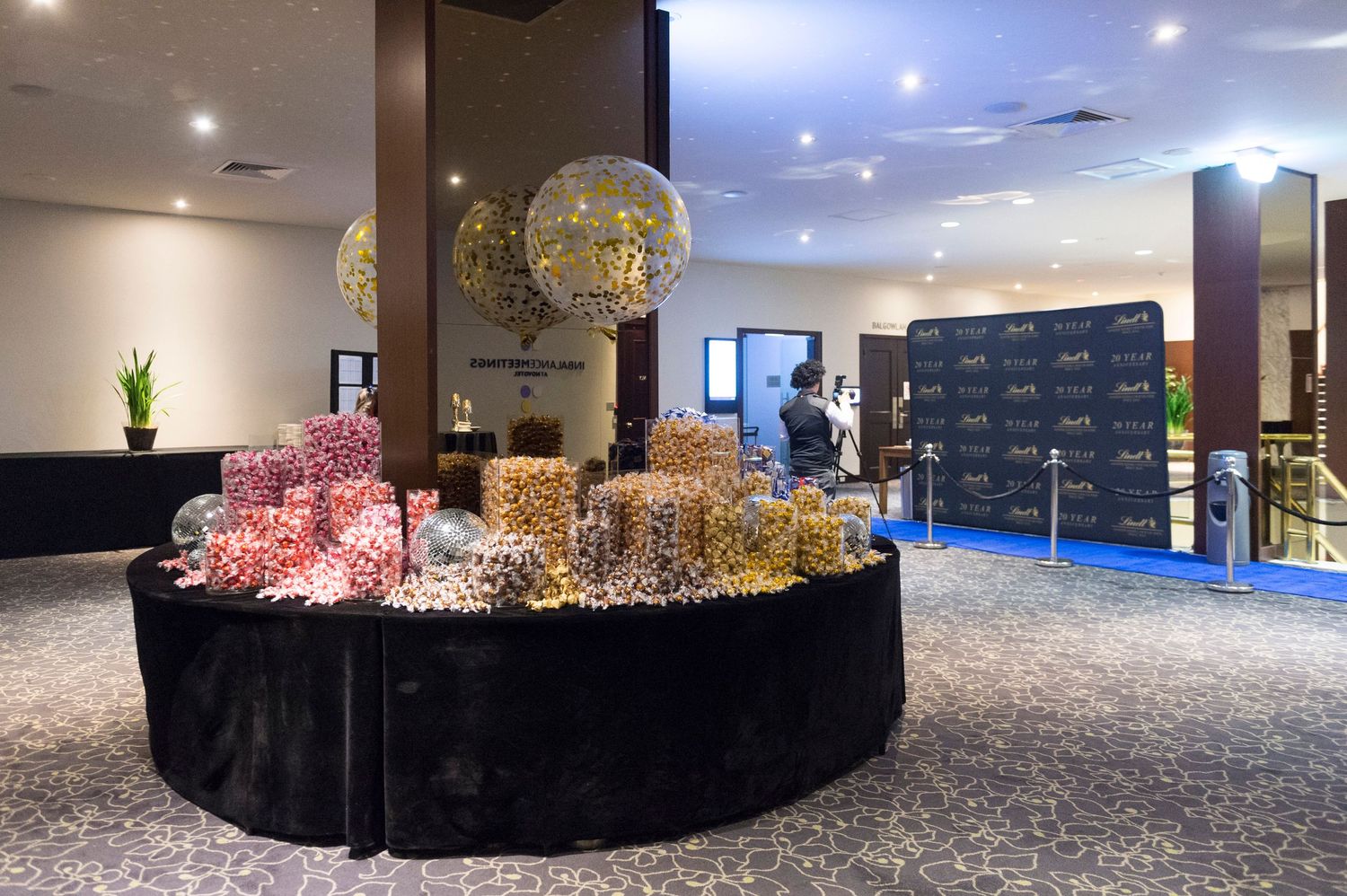 A panoramic view of a modern office interior with illuminated decorative spheres and sleek furnishings.