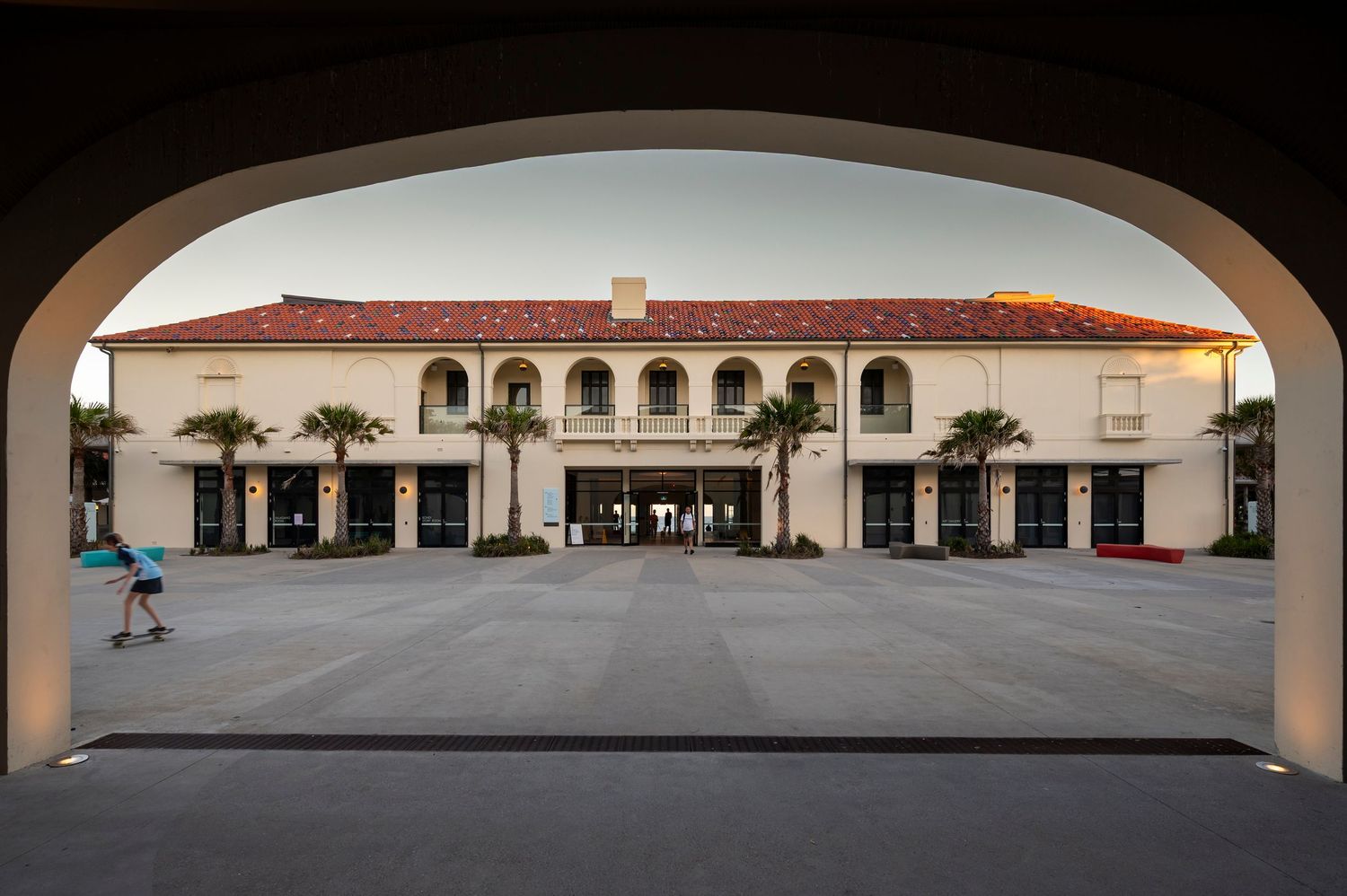Bondi Beach Pavilion building panoramic view of the back facades with arched walkways courtyards and terracotta roof tiles.