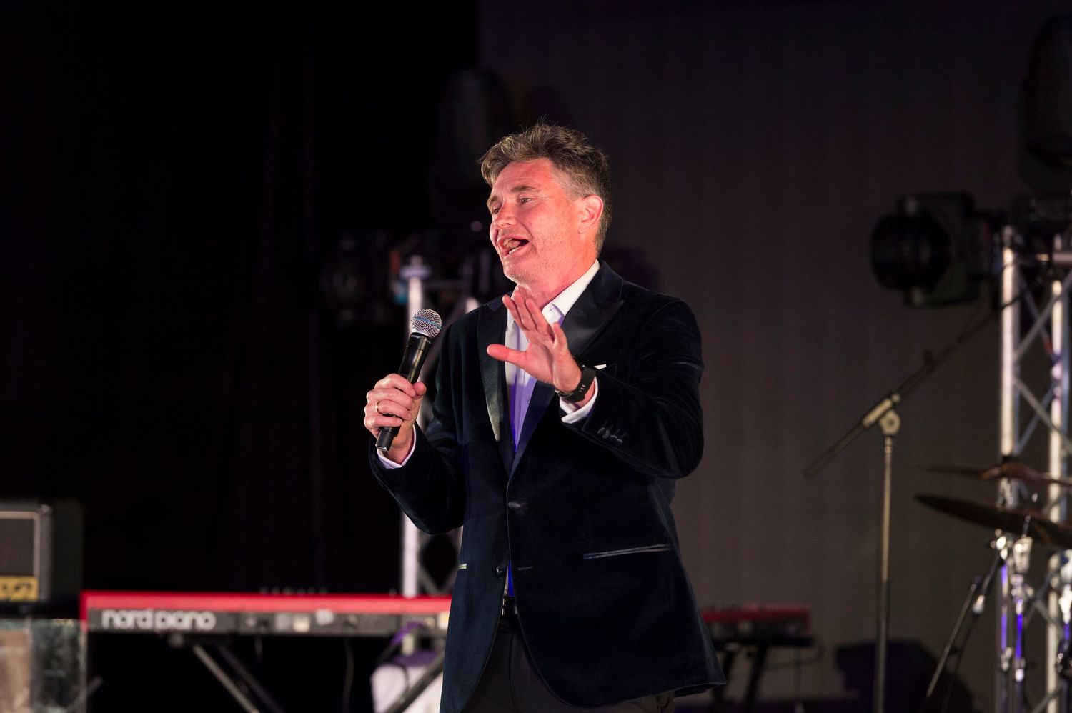 Australian stand-up comedian, television and radio presenter Dave Hughes on stage at a gala dinner sponsored event.