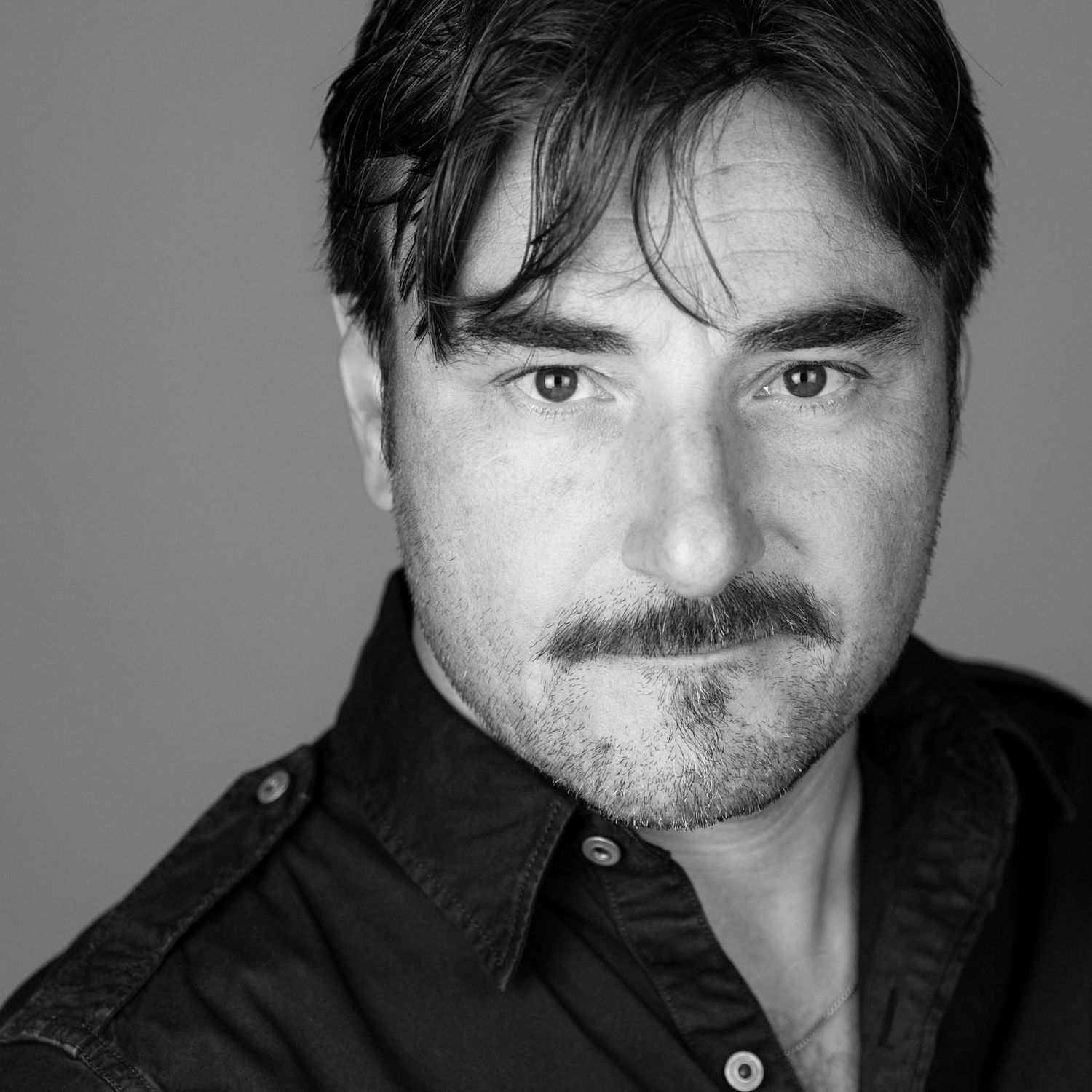 Black and white portrait series showing different facial expressions.