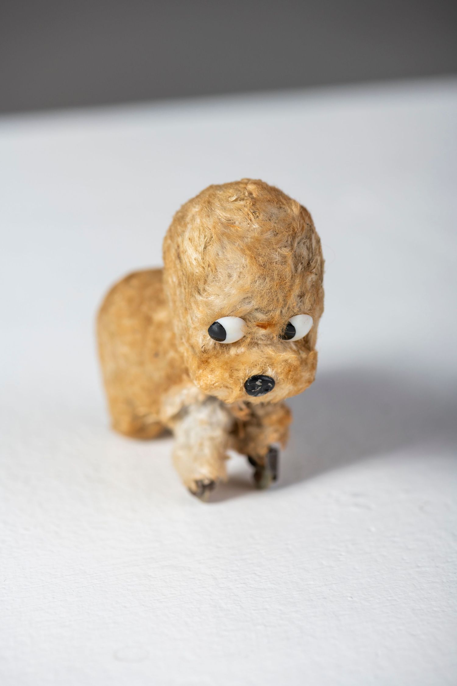 Time-lapse sequence shows the creation of a small clay figure with googly eyes on a white surface.