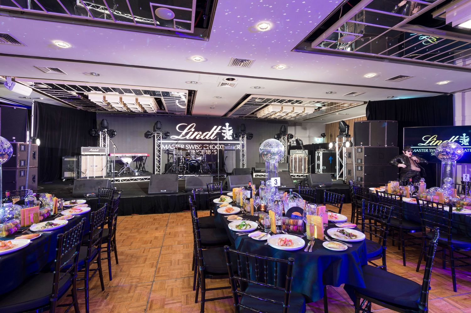 Modern nightclub interior with purple LED lighting, bar seating, and multiple viewing angles showing sleek design elements.