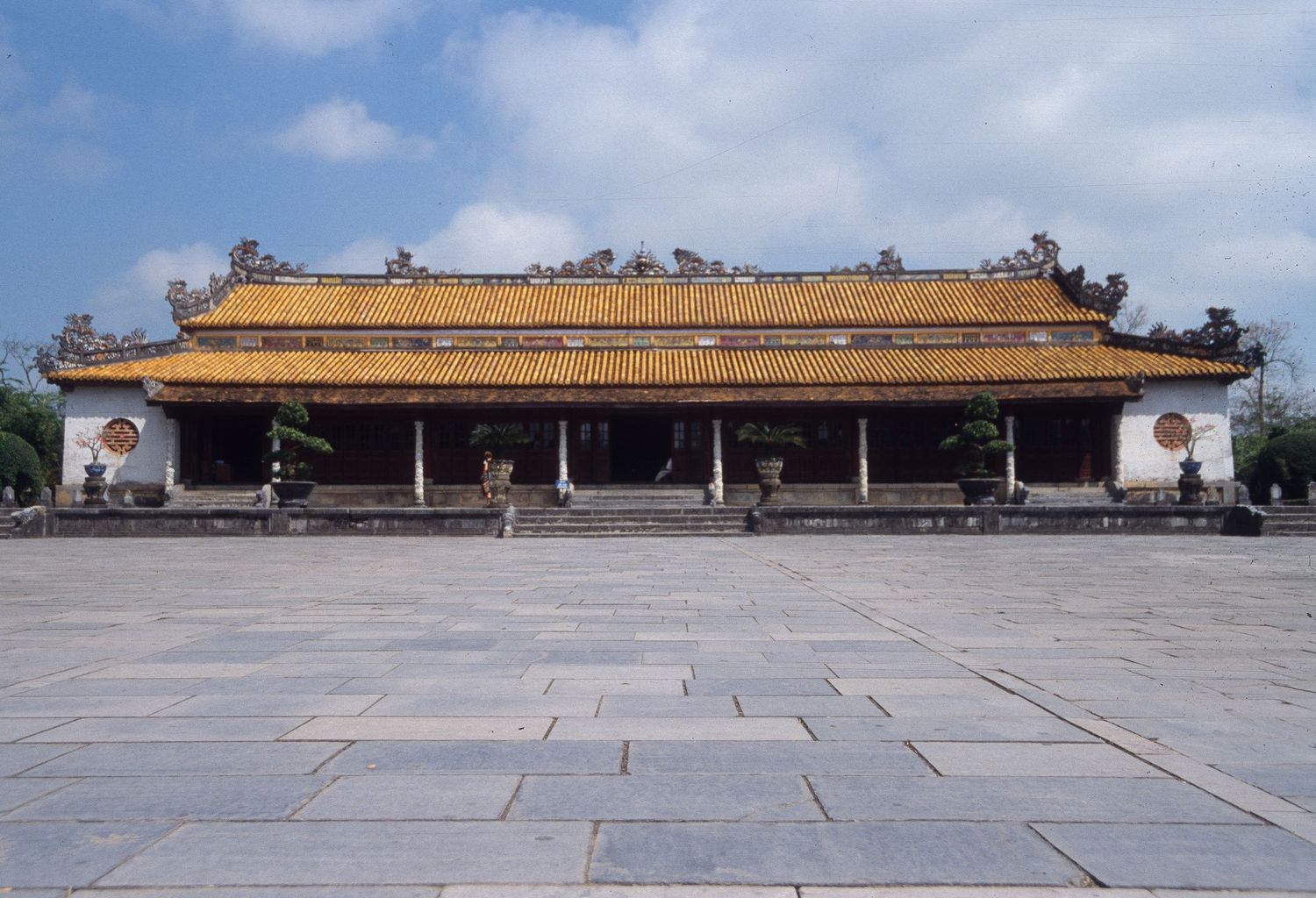 Long panoramic view of a traditional Chinese imperial palace building with yellow tiled roof.