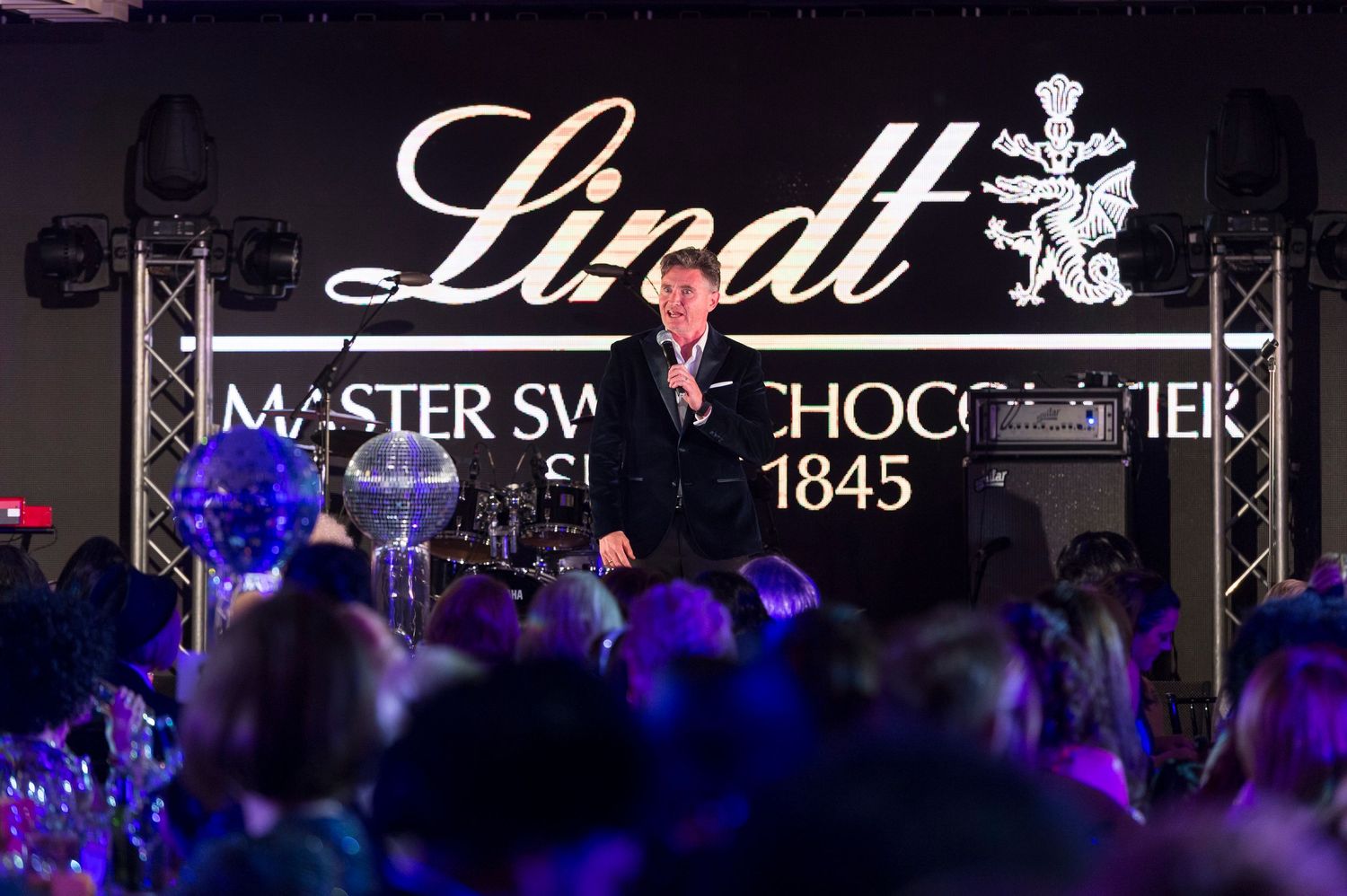 Australian stand-up comedian, television and radio presenter Dave Hughes on stage at a gala dinner sponsored event.