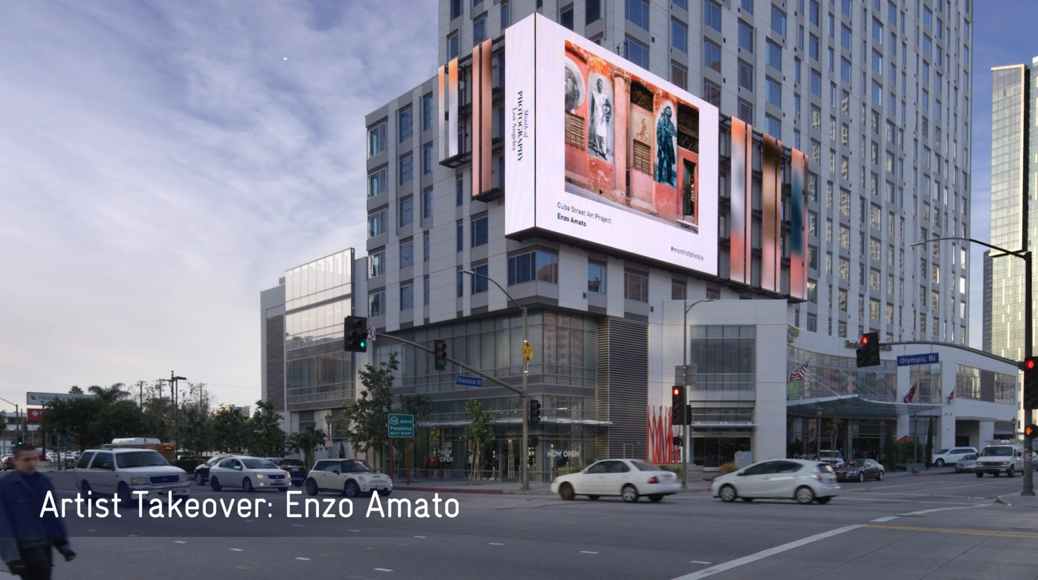A panoramic view of modern high-rise buildings and billboards in down town LA with artist projection.