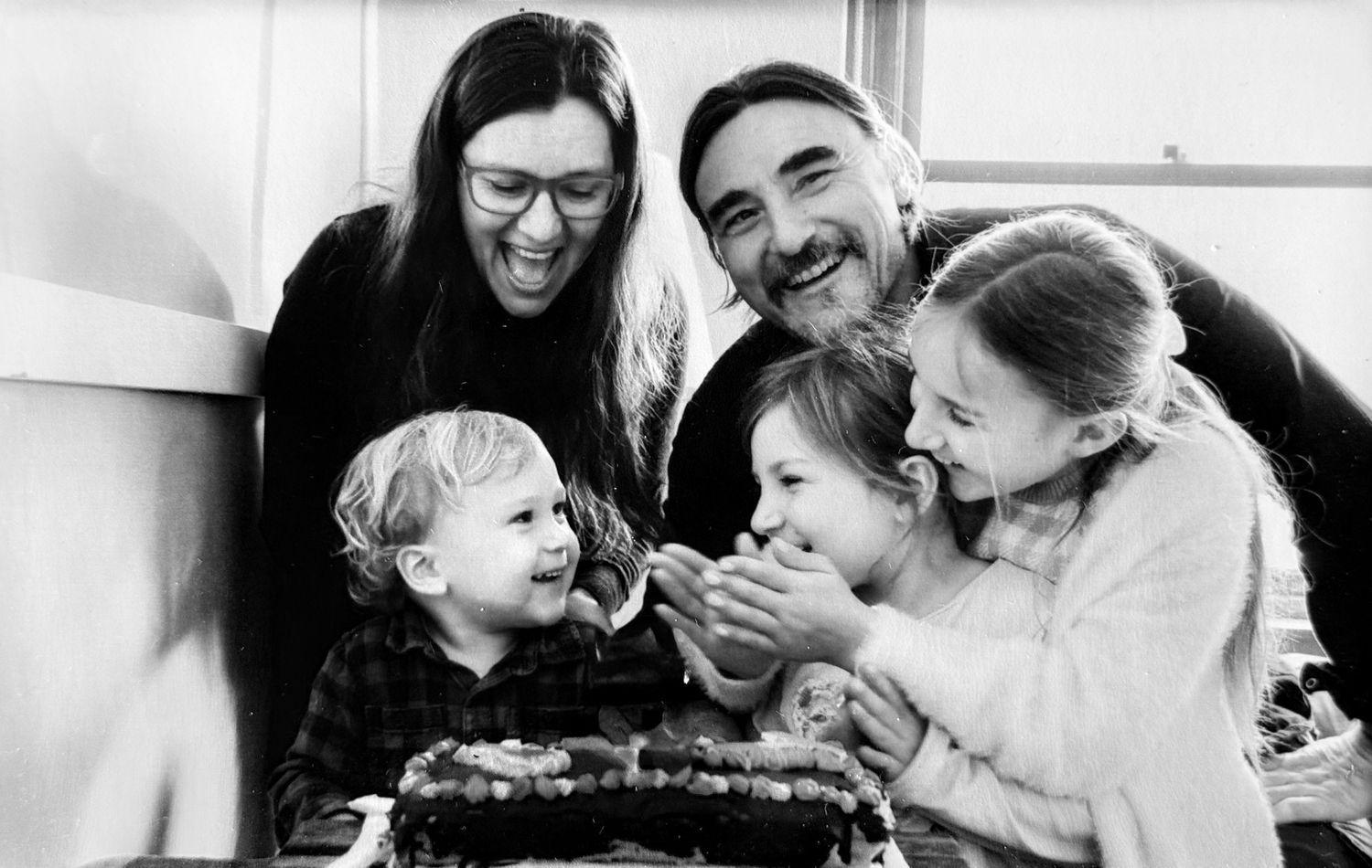 Black and white candid family moments showing laughter and connection.