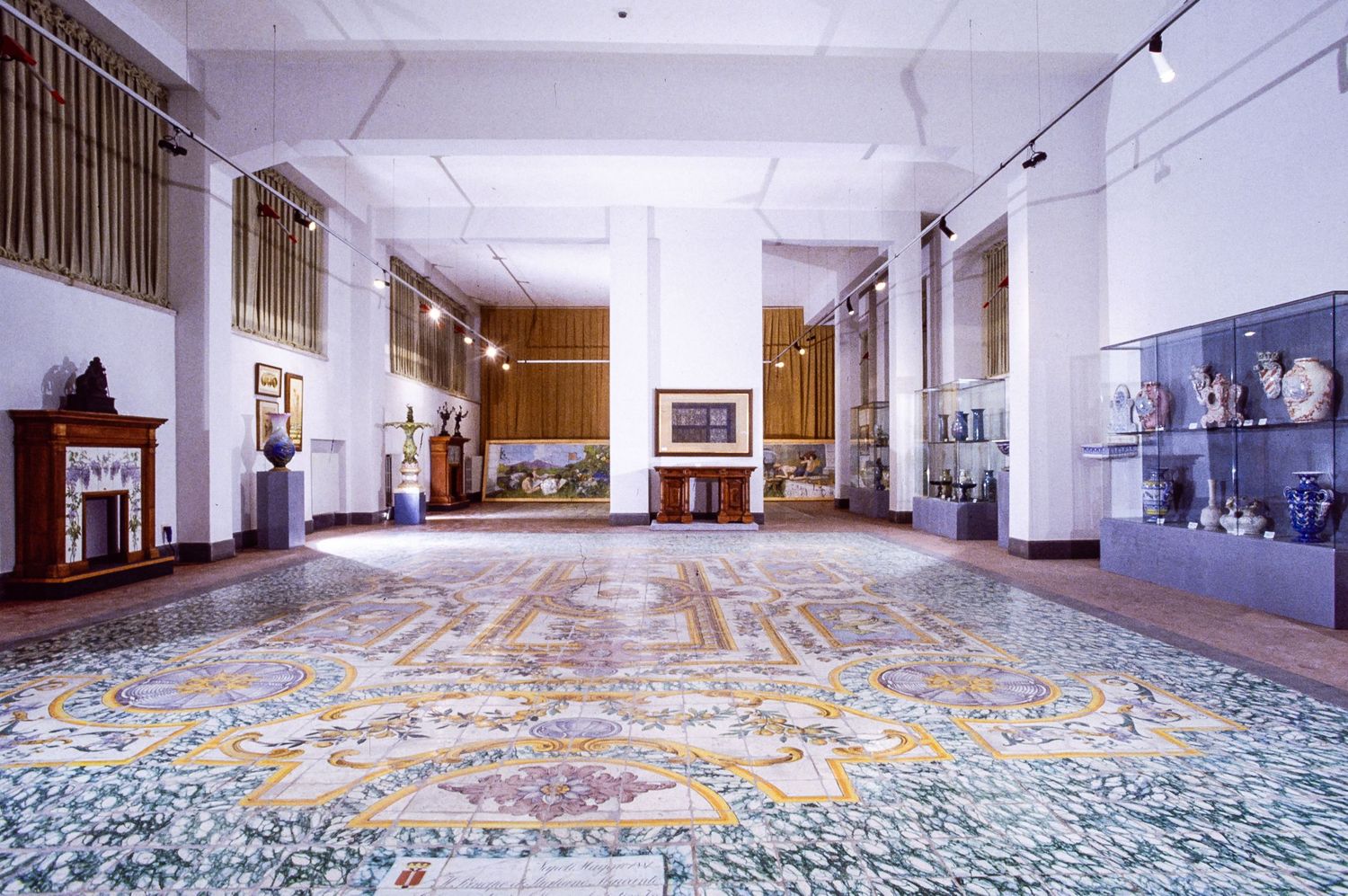 MAI Museo artistico industriale Interior view of gallery space with ornate tiled floor and walls with wooden display and other artefacts