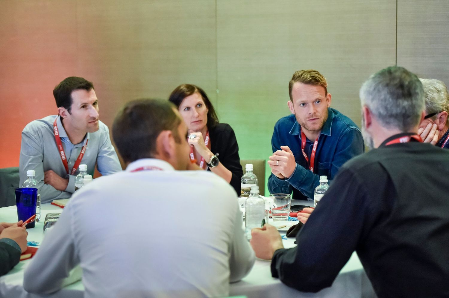 Professionals engaged in discussion during a business symposium meeting Rydges Hotel & Resorts.