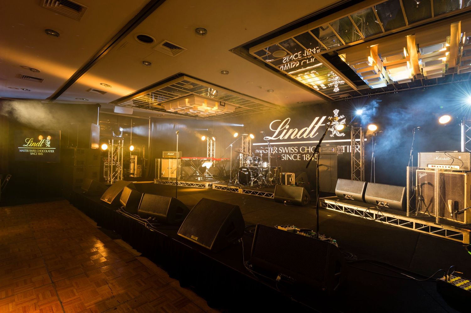 A dimly lit nightclub interior with dark leather booths and atmospheric lighting creating a moody ambiance.