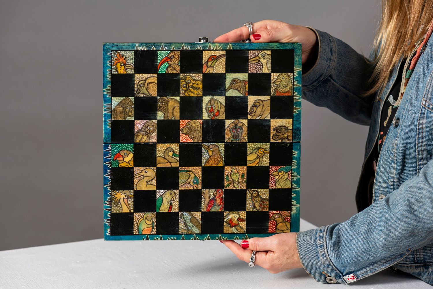 Checkered pattern design featuring alternating black squares and gold sunflower motifs.