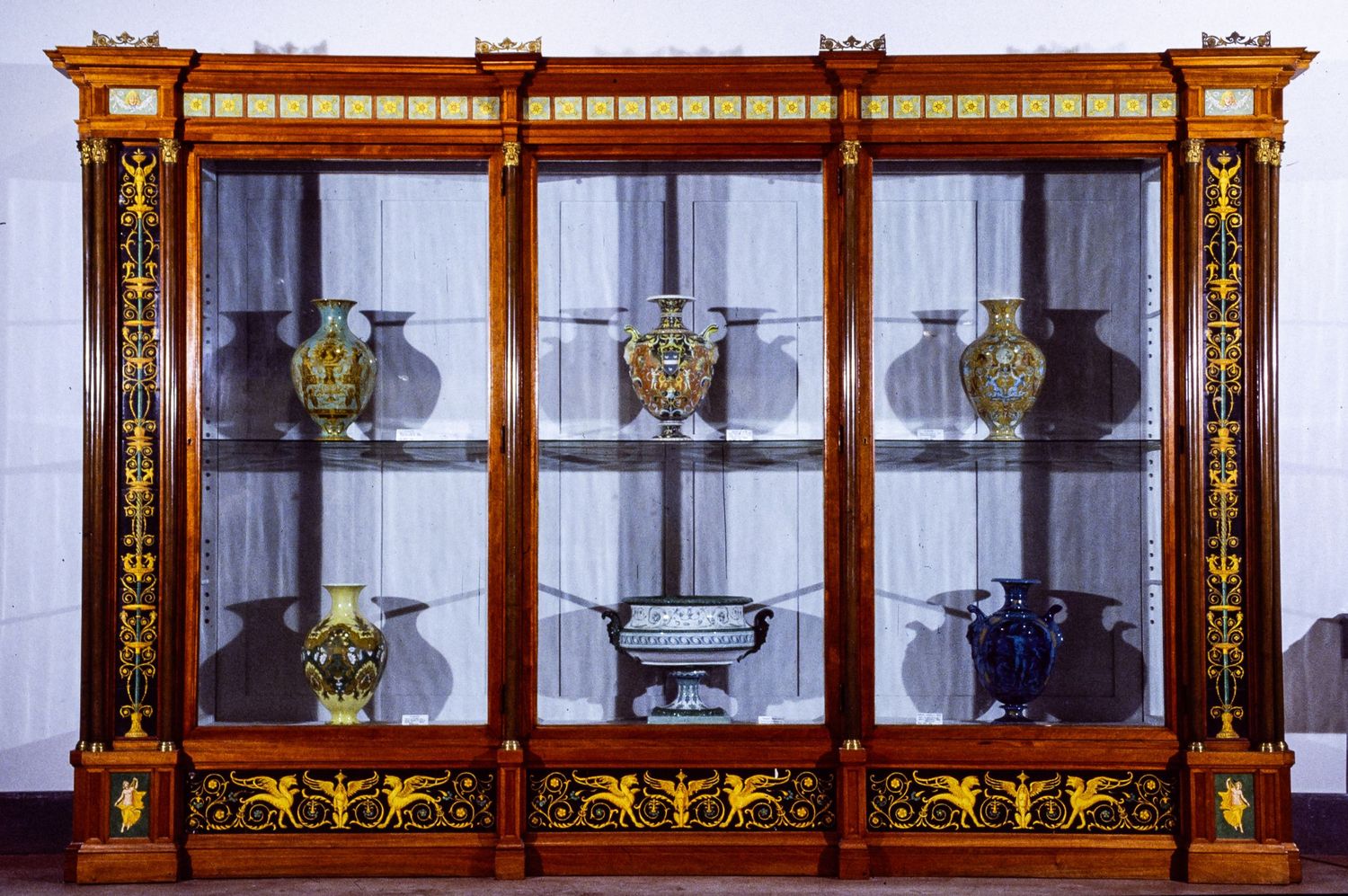 MAI Museo artistico industriale Filippo Palizzi wooden display cabinet with glass panels showcasing antique artifacts and decorative items.