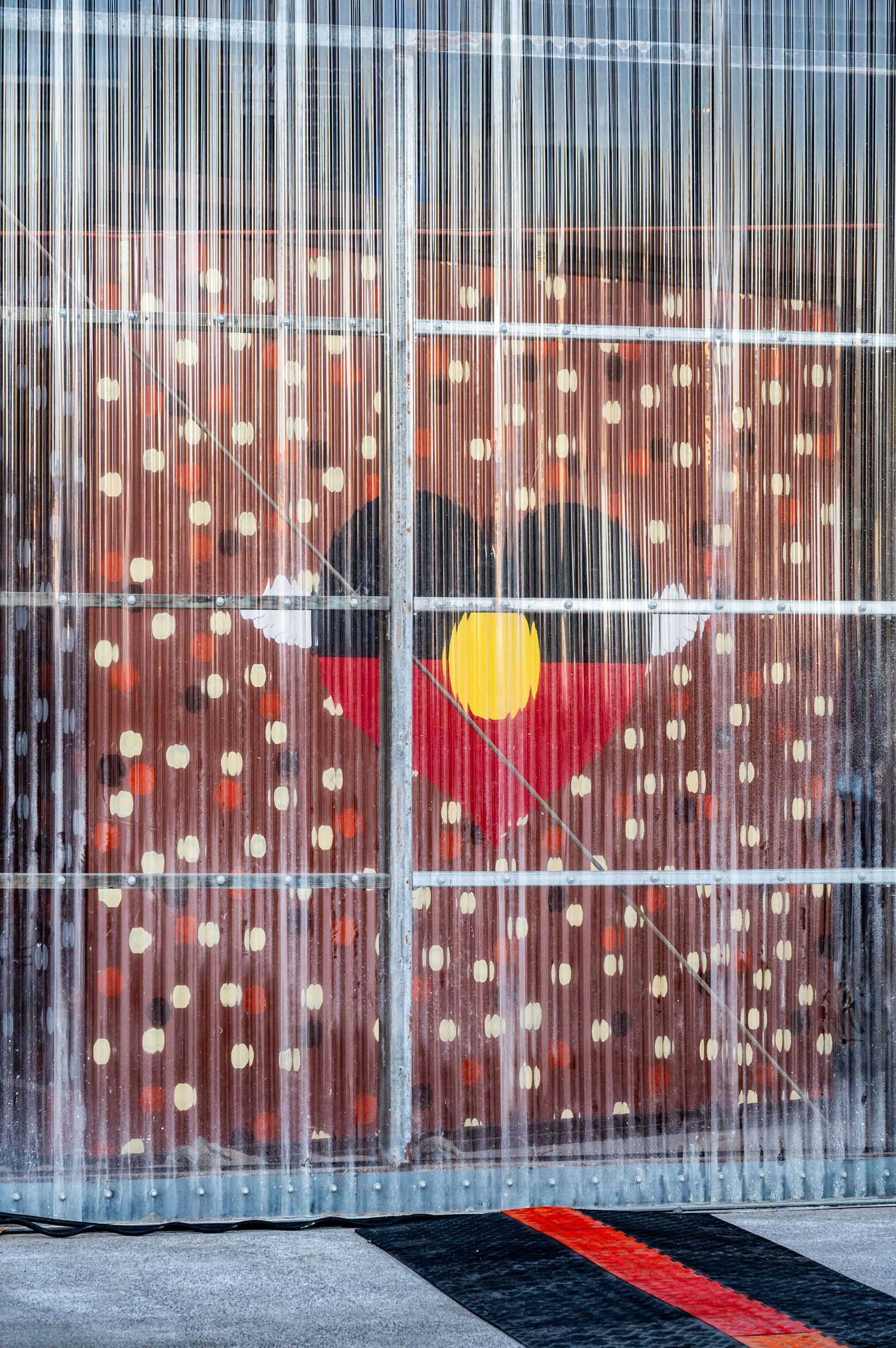 Biennale of Sydney White Bay Power Station, Aboriginal art installation with yellow circle behind translucent striped panels.