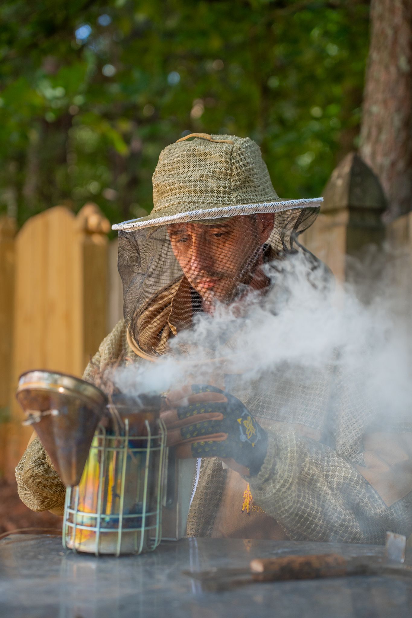 Man setting up smoker for beehive