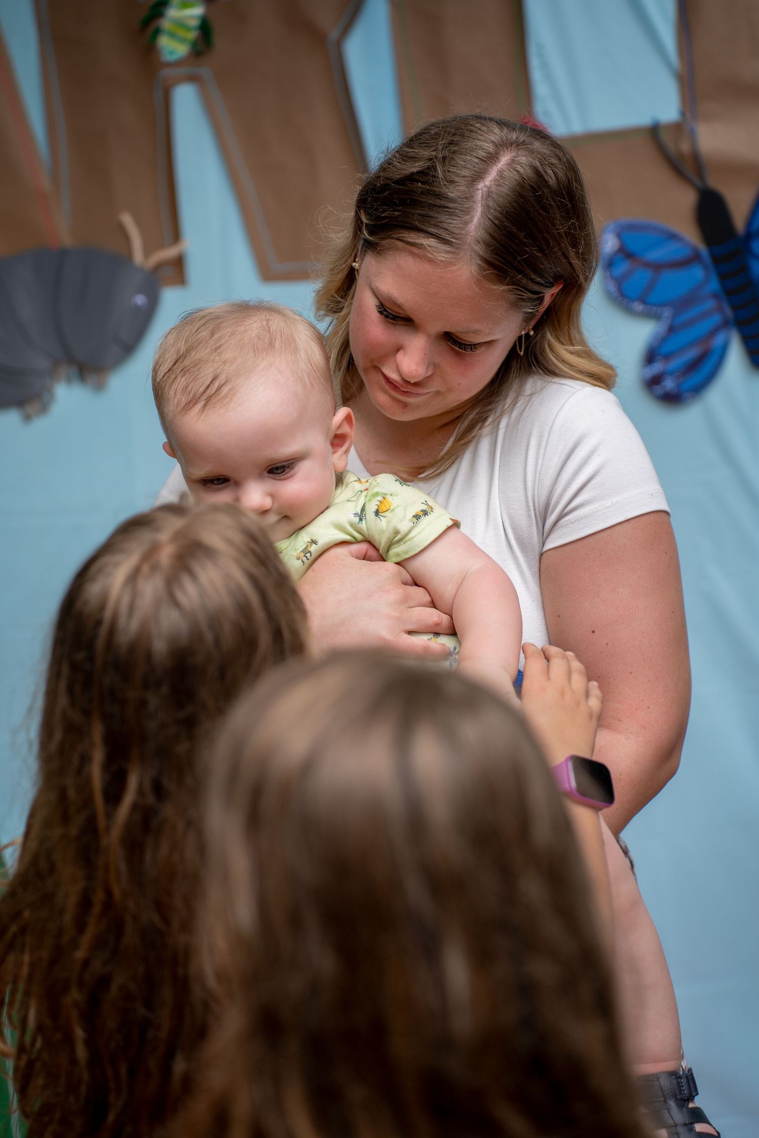 Toddler being help