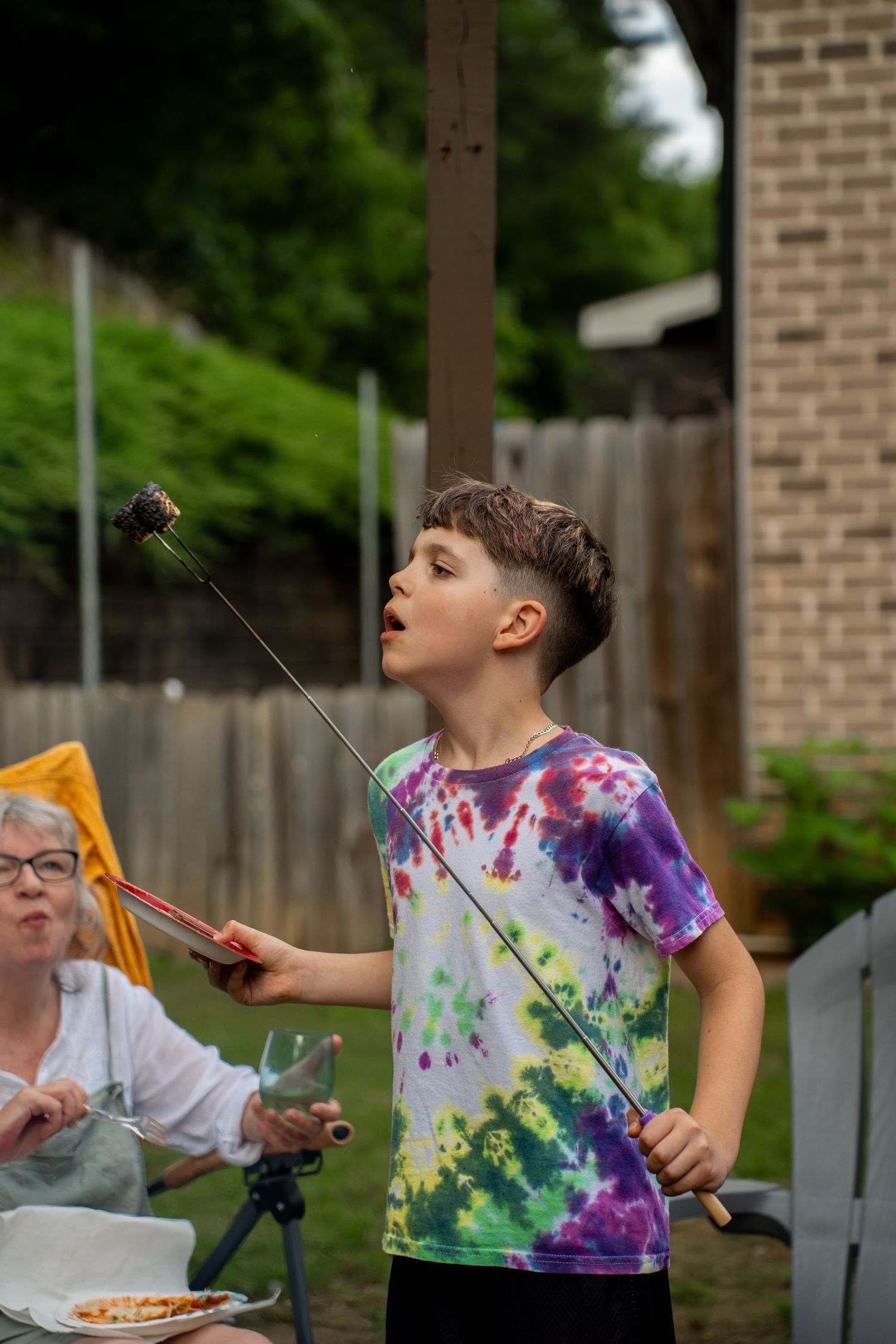 Boy blowing out toasted marshmallow