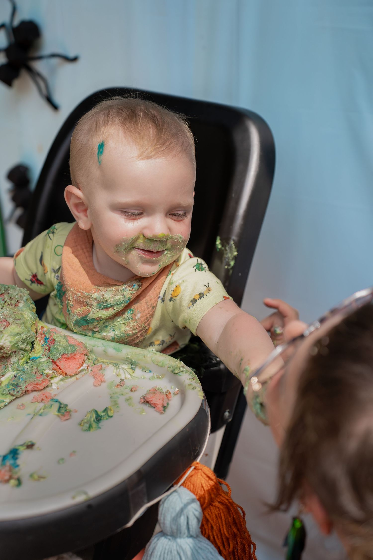 Toddler feeding cake to mum
