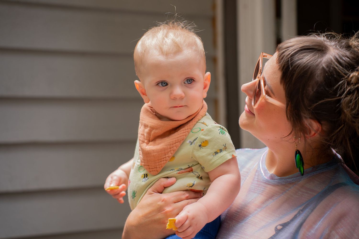 Toddler being held by mum