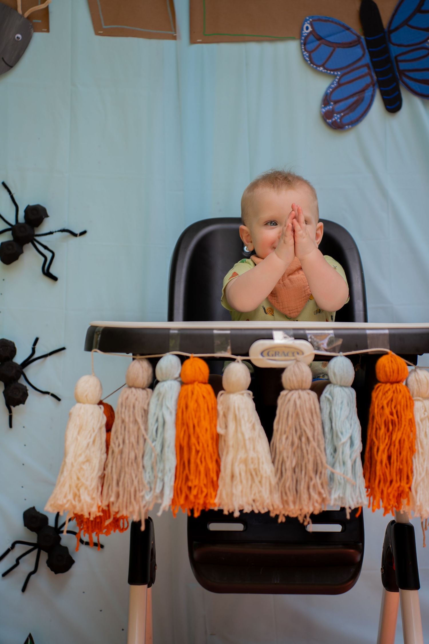 Toddler in high chair clapping