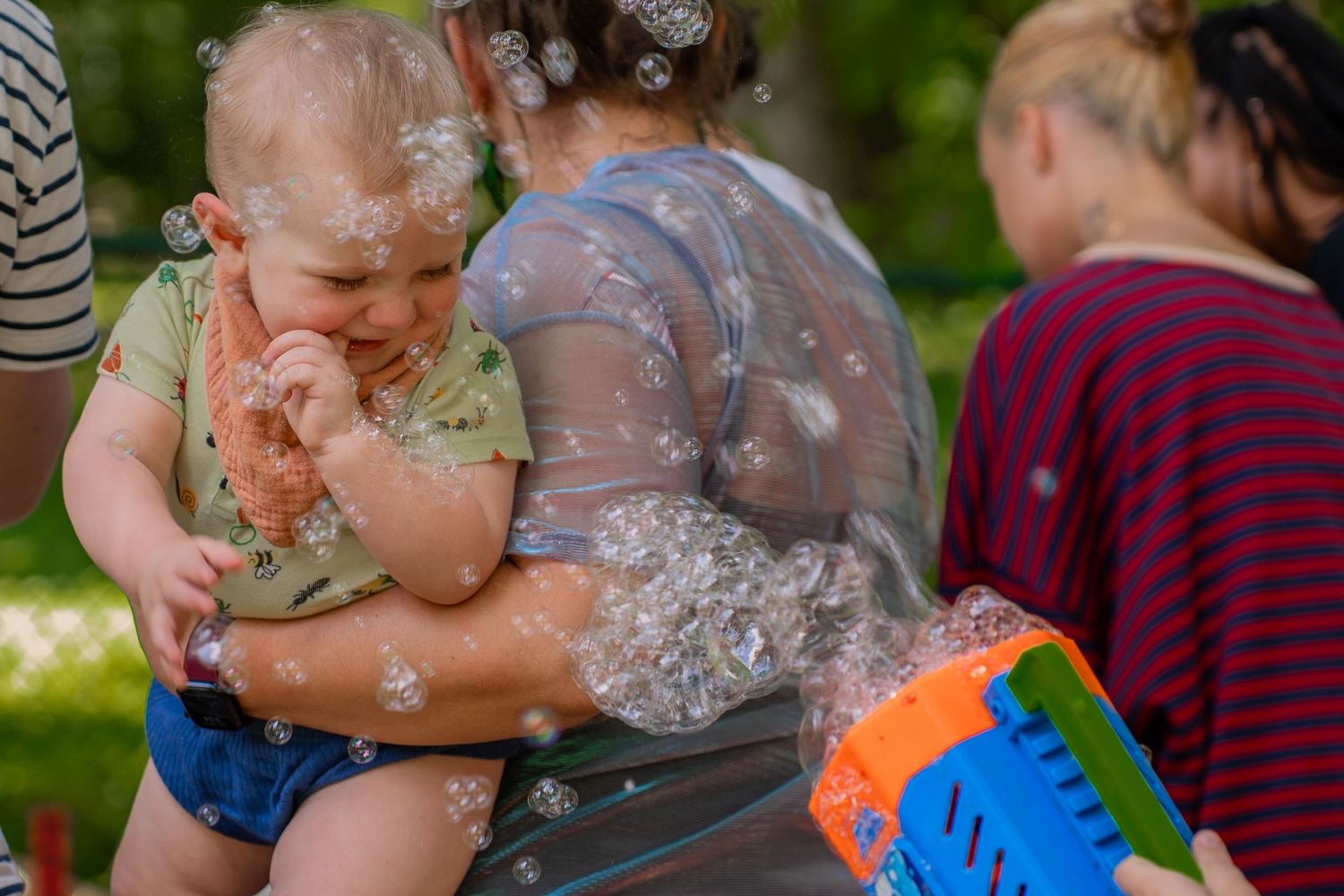 Bubbles being blown in toddlers face