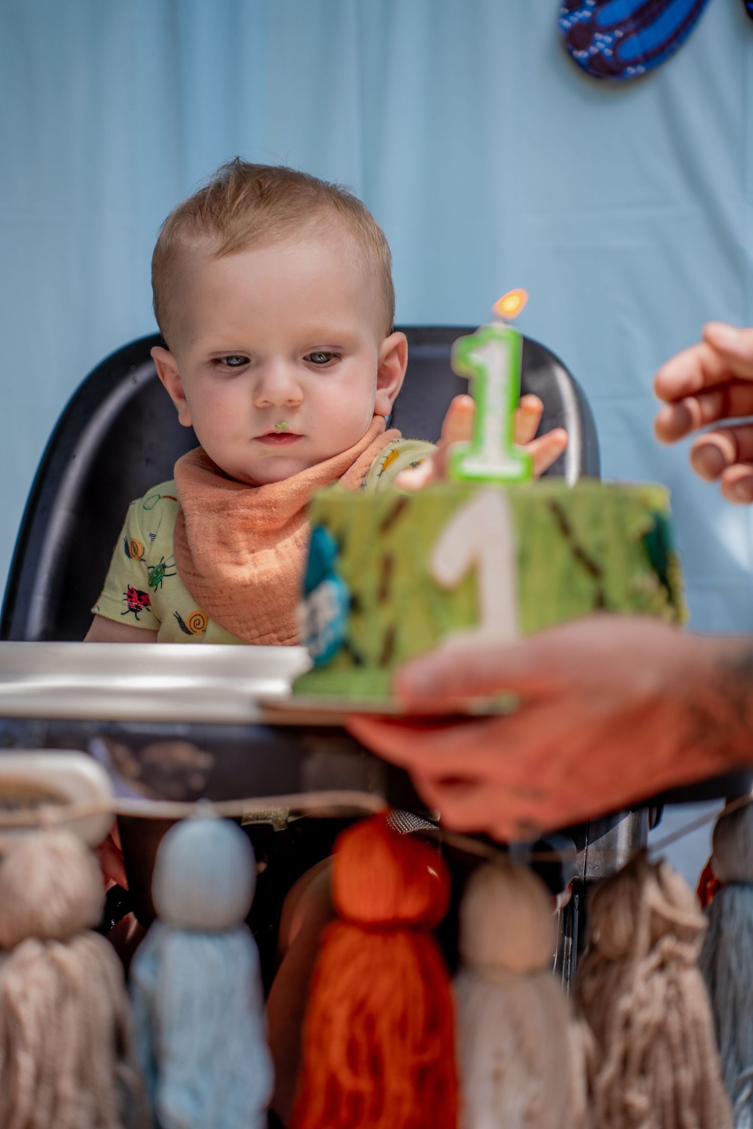 1 birthday cake with candle with waiting toddler