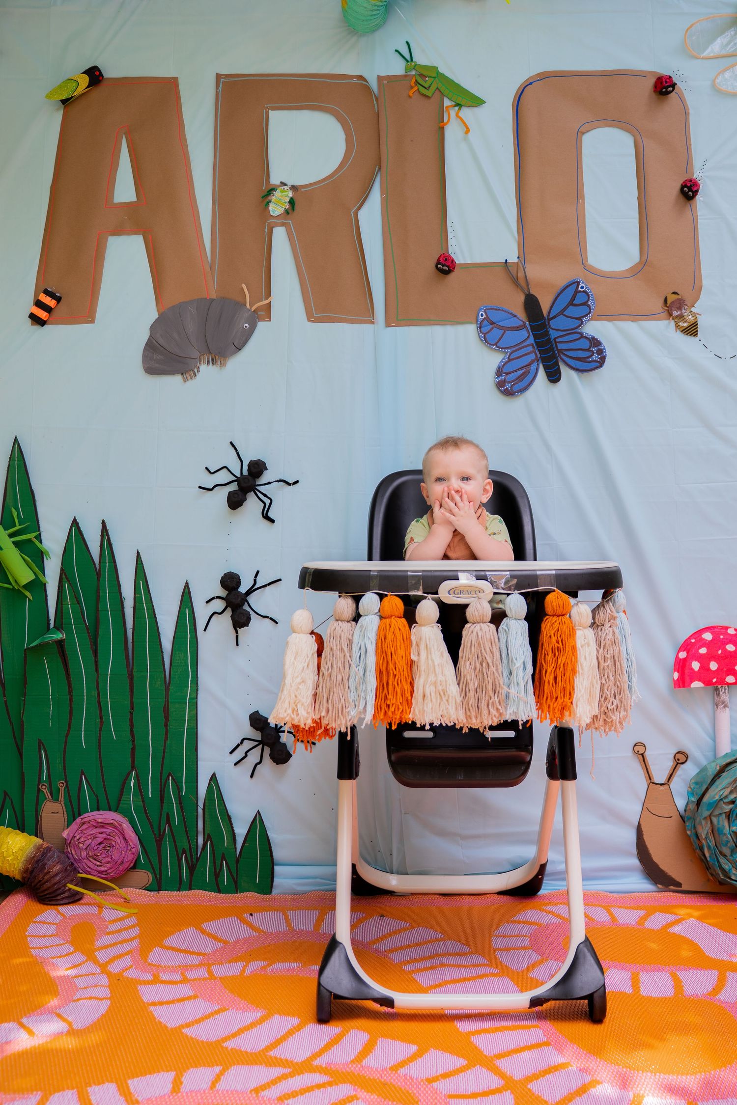 Toddler in high chair covering his mouth