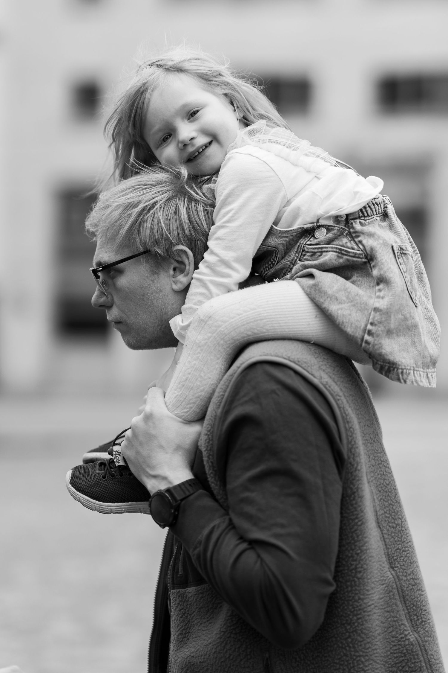 Black and white sequence showing playful piggyback ride moments outdoors.