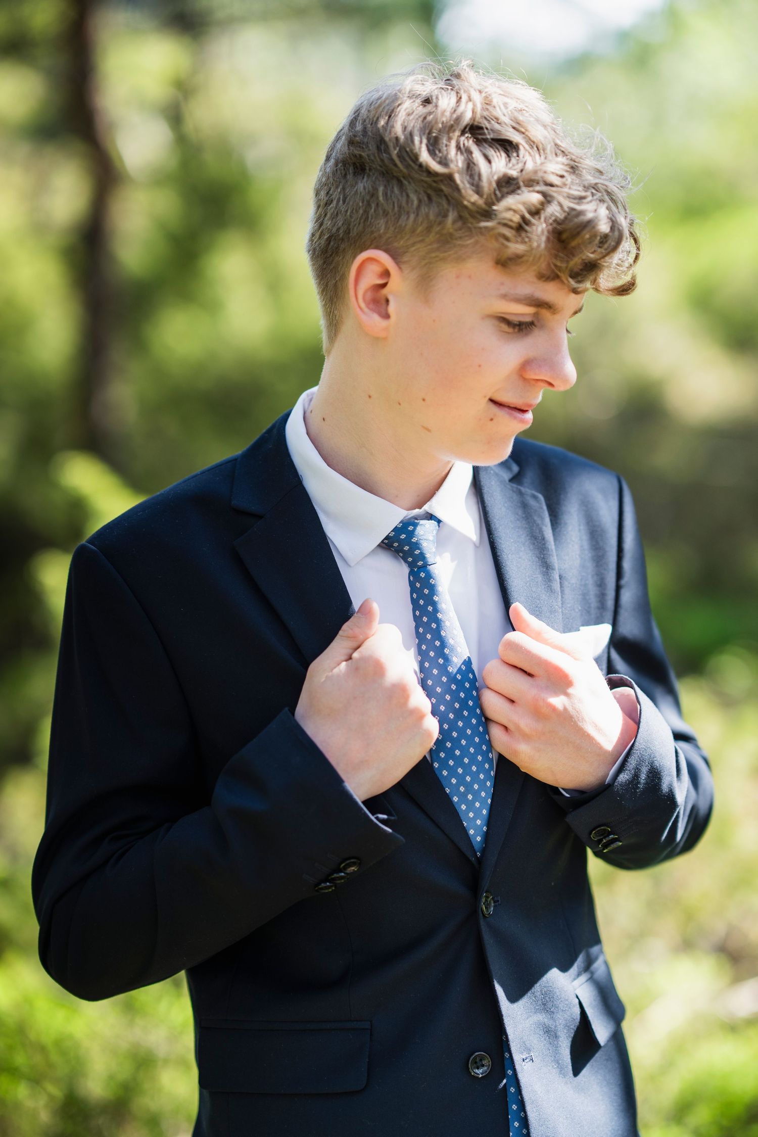 Series of shots showing someone adjusting their collar and tie outdoors.