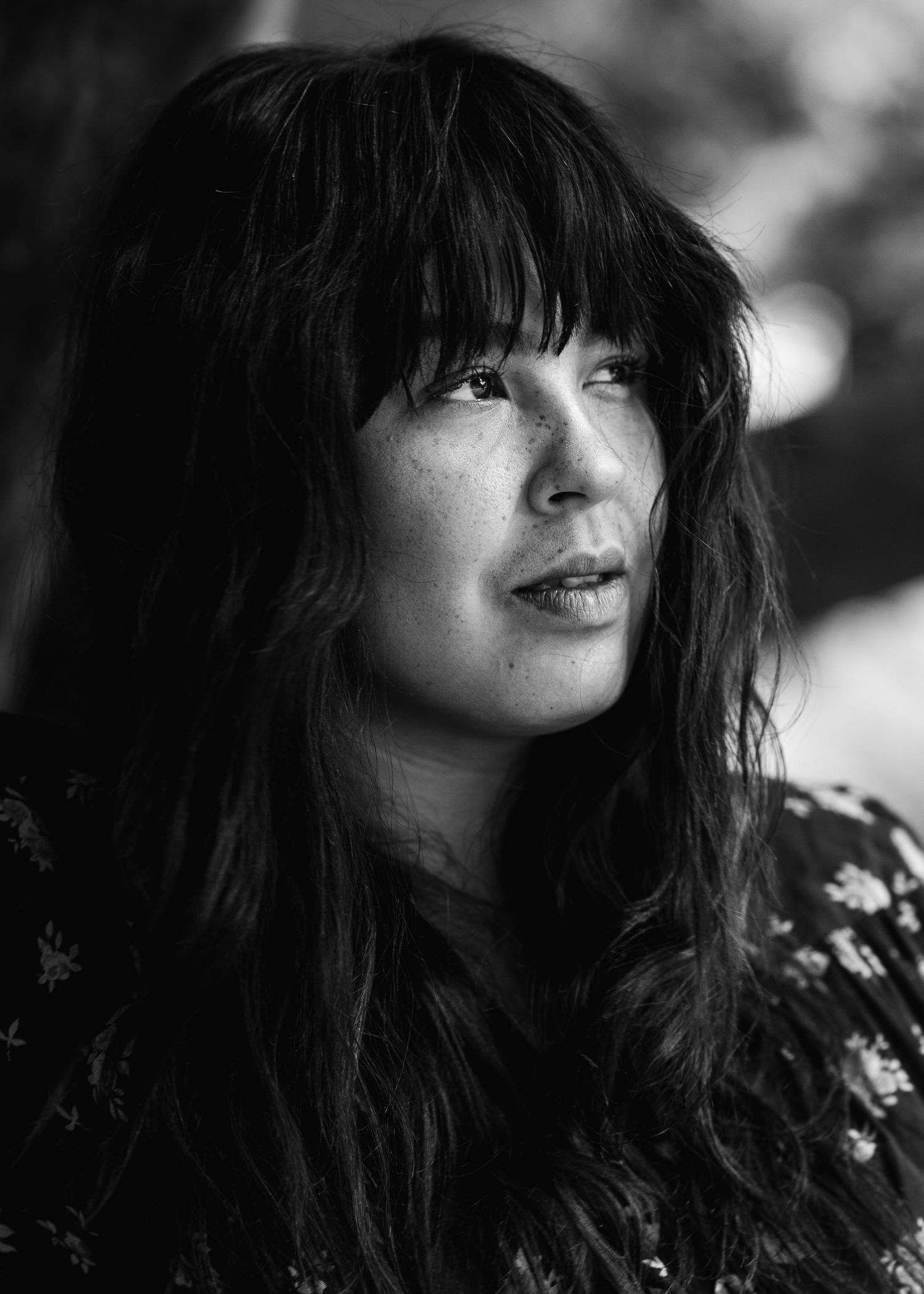 Dramatic black and white headshots showing textured hair and floral pattern clothing.